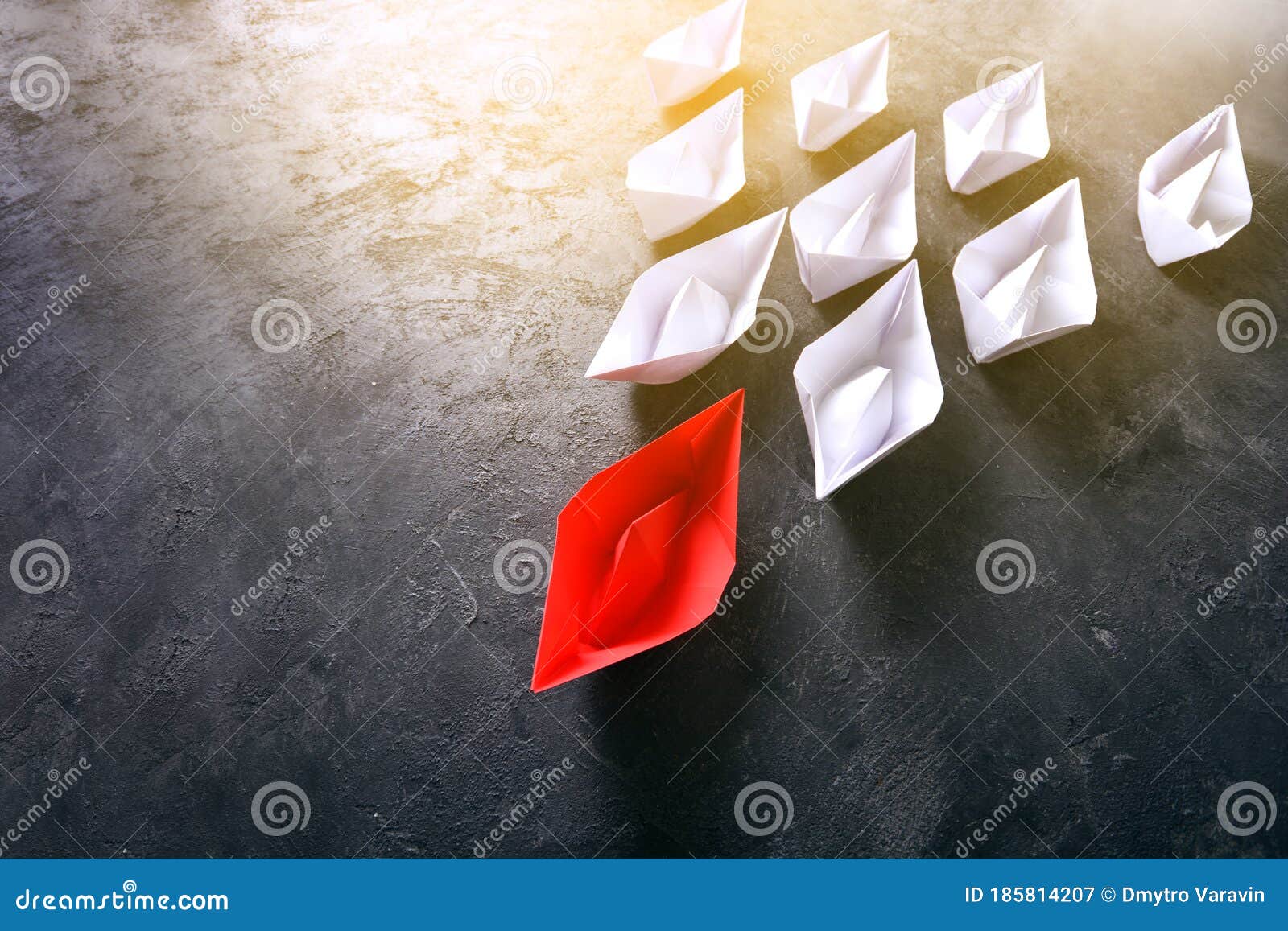 leader concept with red paper boat leading white paper boats