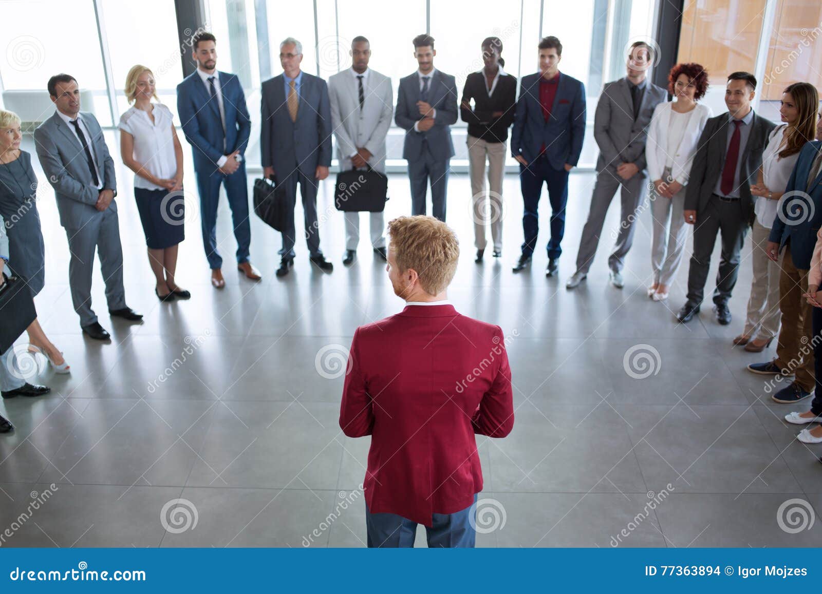 leader standing in front of his successful business team