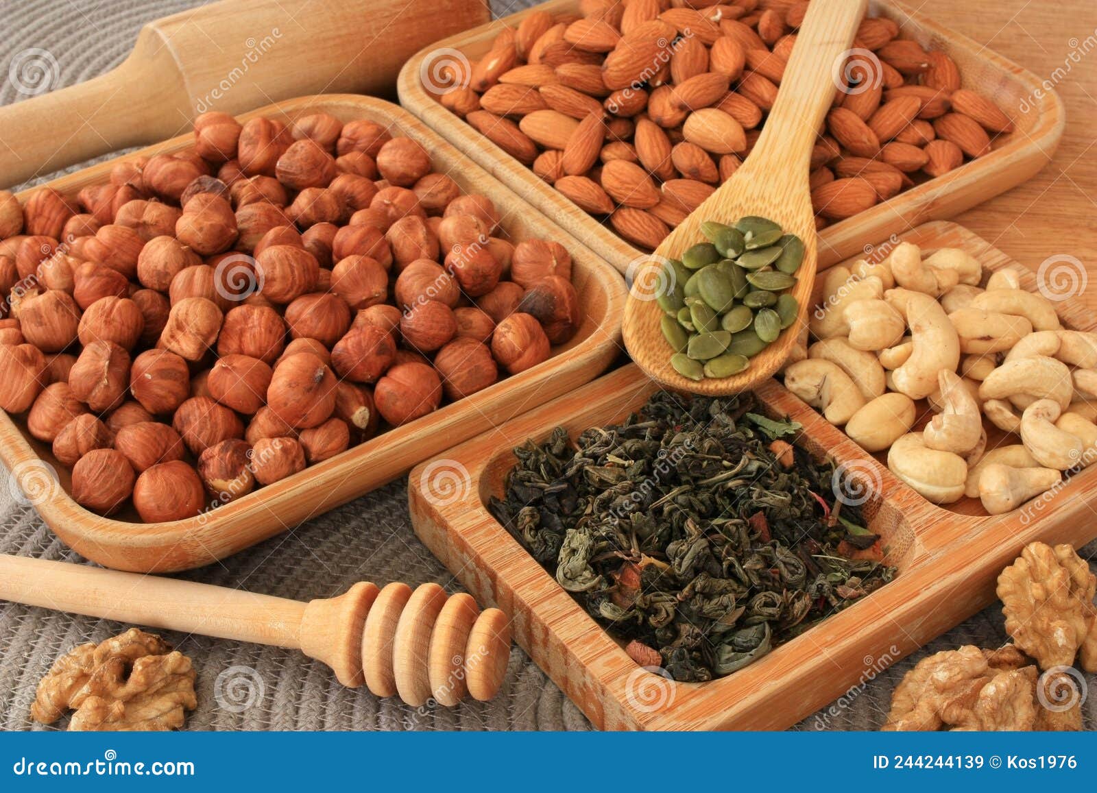 Leafy green tea and nuts stock image. Image of nutshell 244244139