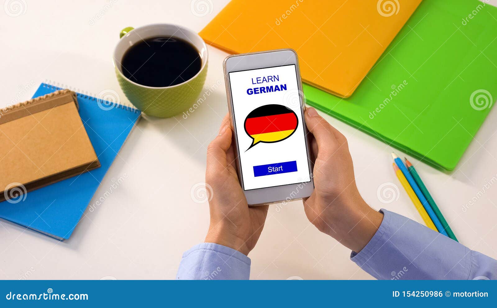 Learn German Application on Cellphone in Persons Hands, Studying