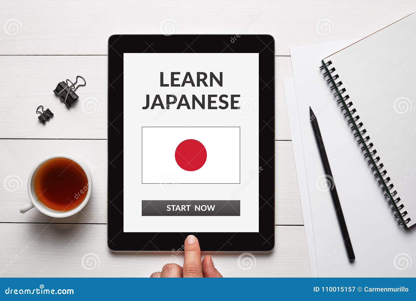 Learn Japanese Concept on Tablet Screen with Office Objects Stock Image