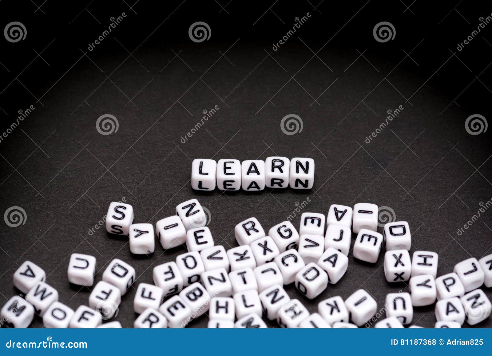 Learn text from plastic letter cubes. Learn word from plastic letter cubes on black background