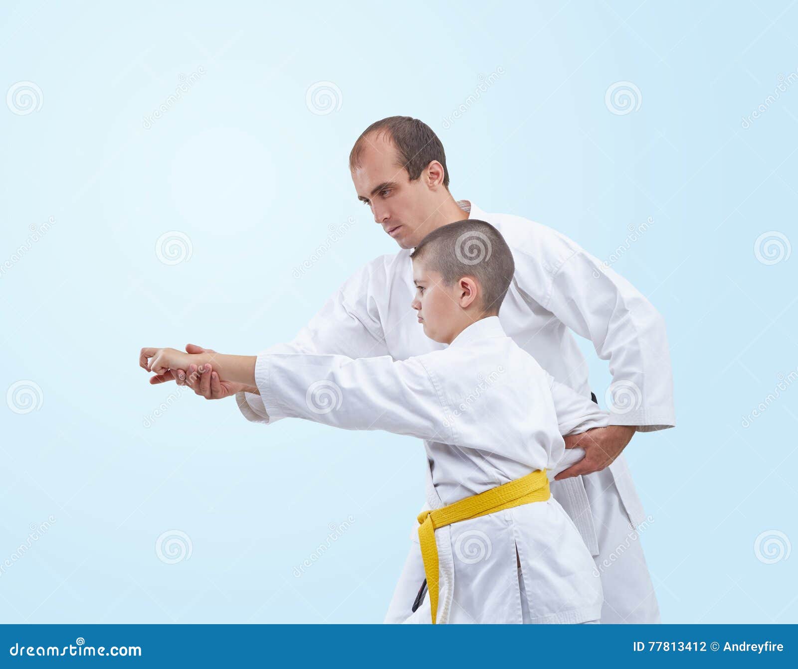 The Learner with a Yellow Belt Karate Coach Corrects Stock Photo
