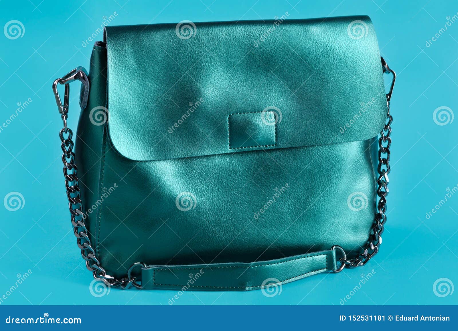 Leather Green Women`s Bag, on a Turquoise Background, Long Handle