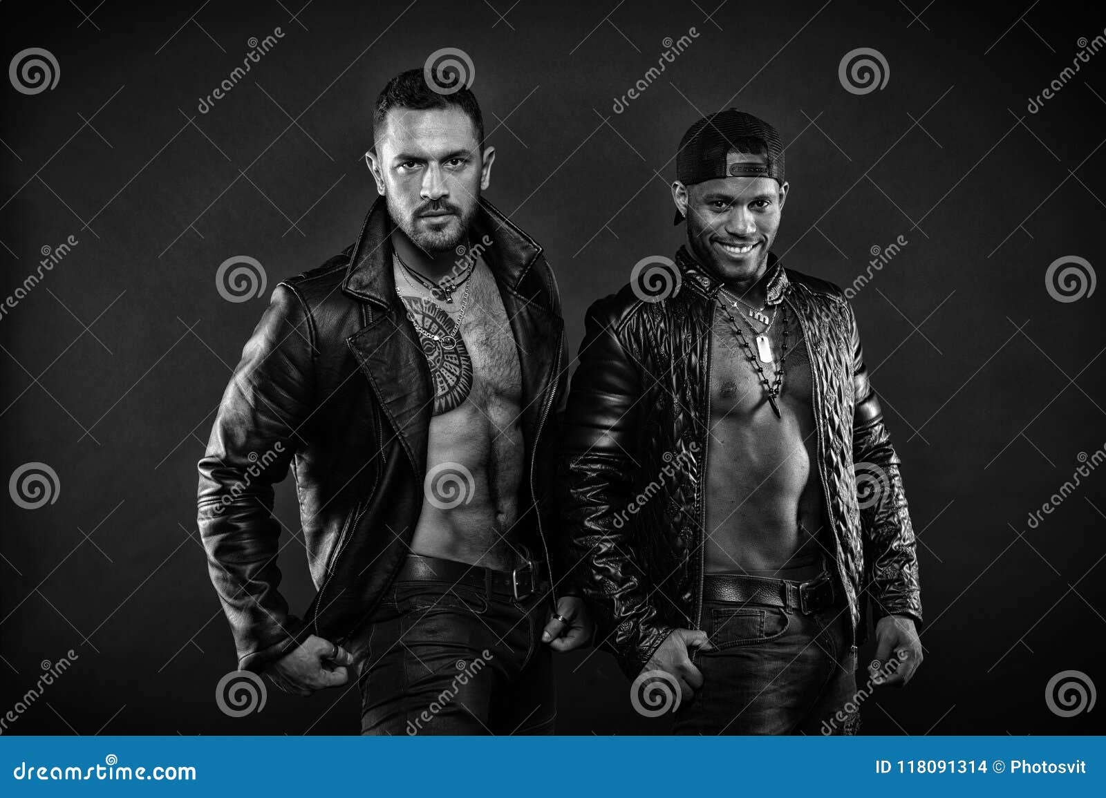 leather masculine clothing concept. men with muscular torsos look brutally. machos with muscular torsos look