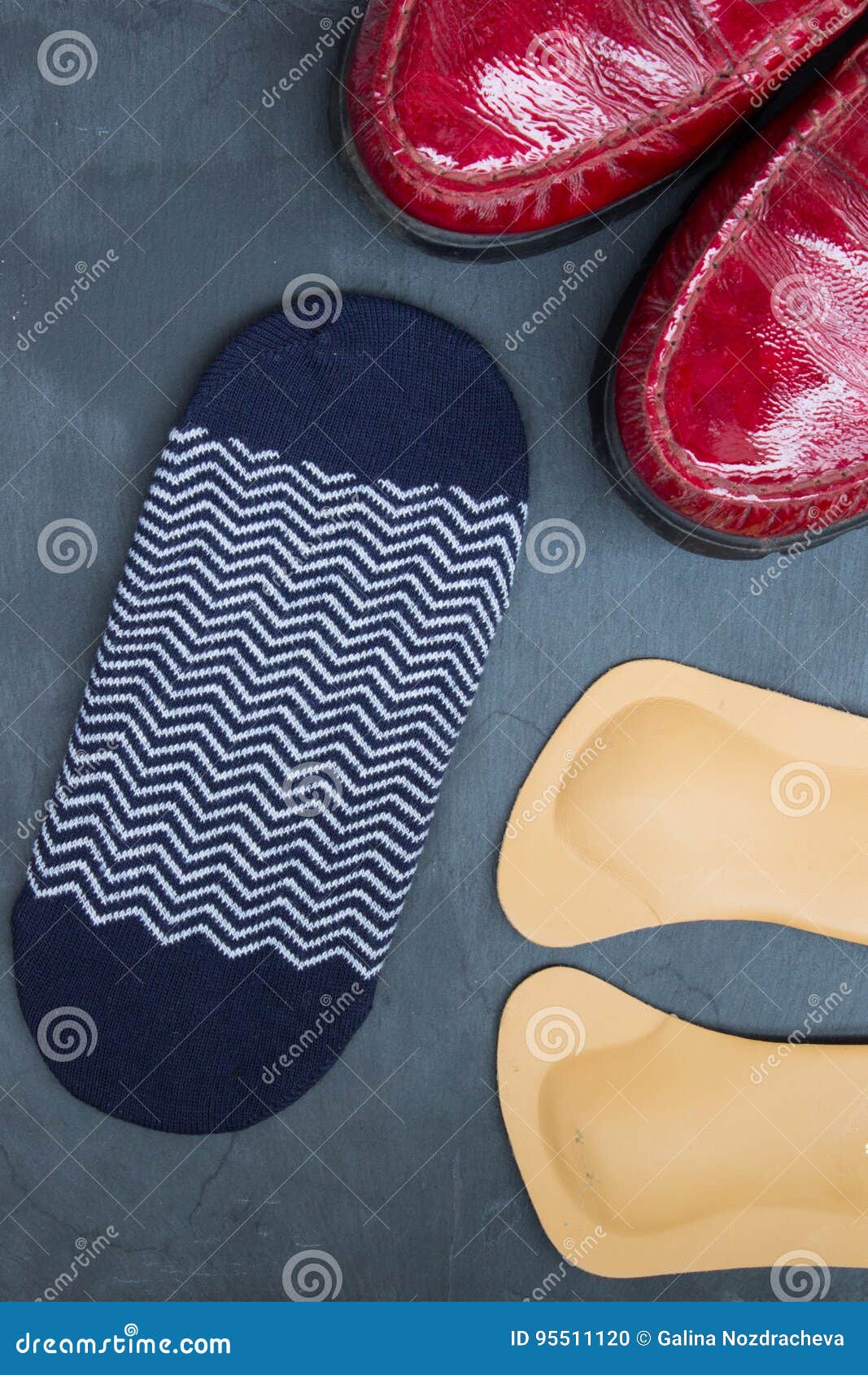 Leather Orthopedic Insoles, Socks and Red Shoes on Stone Background ...