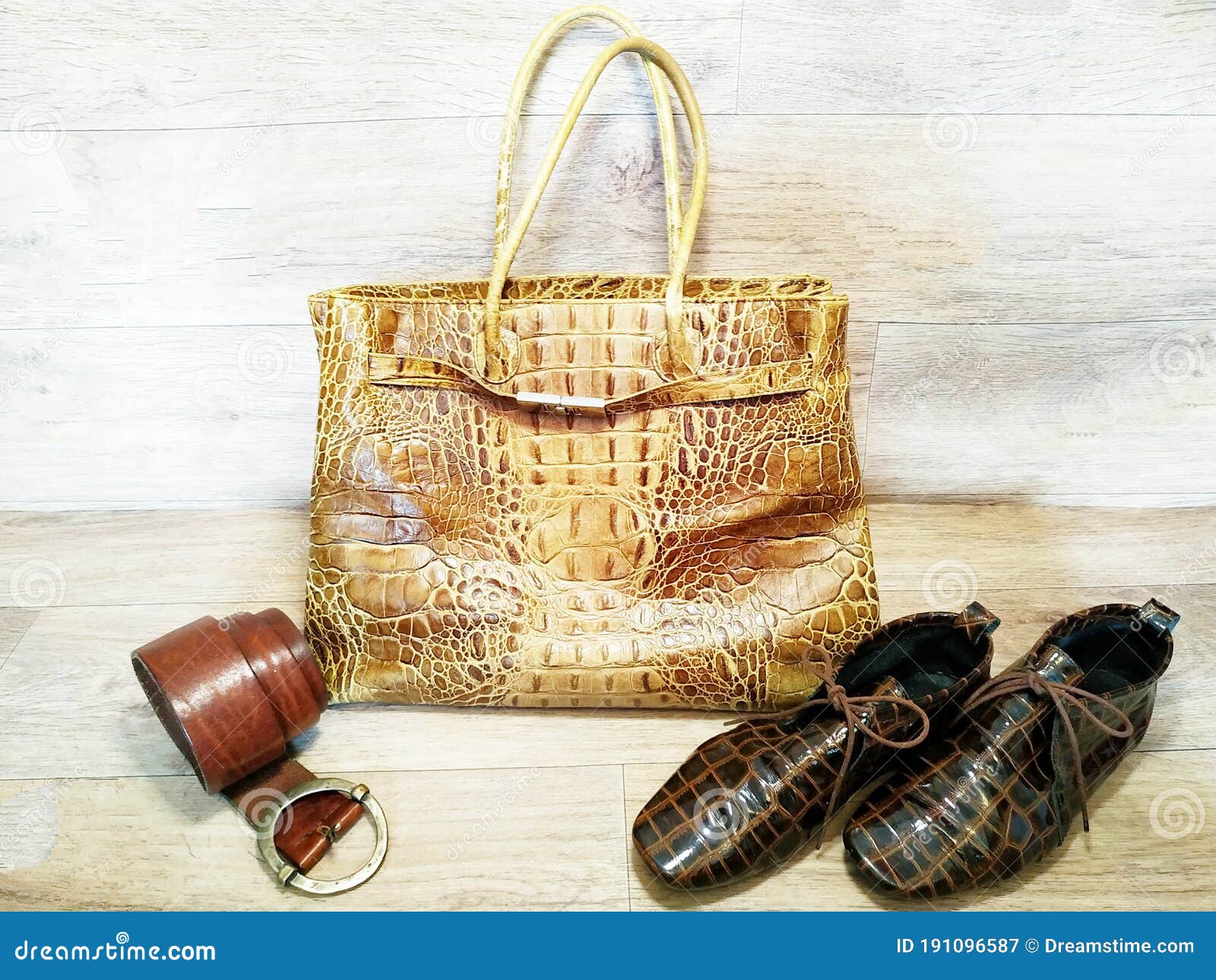 leather products: bags, shoes, belts on a wooden textured background