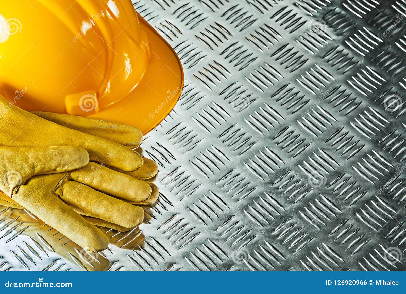 Leather Protective Gloves Hard Hat on Fluted Metal Texture Stock Photo