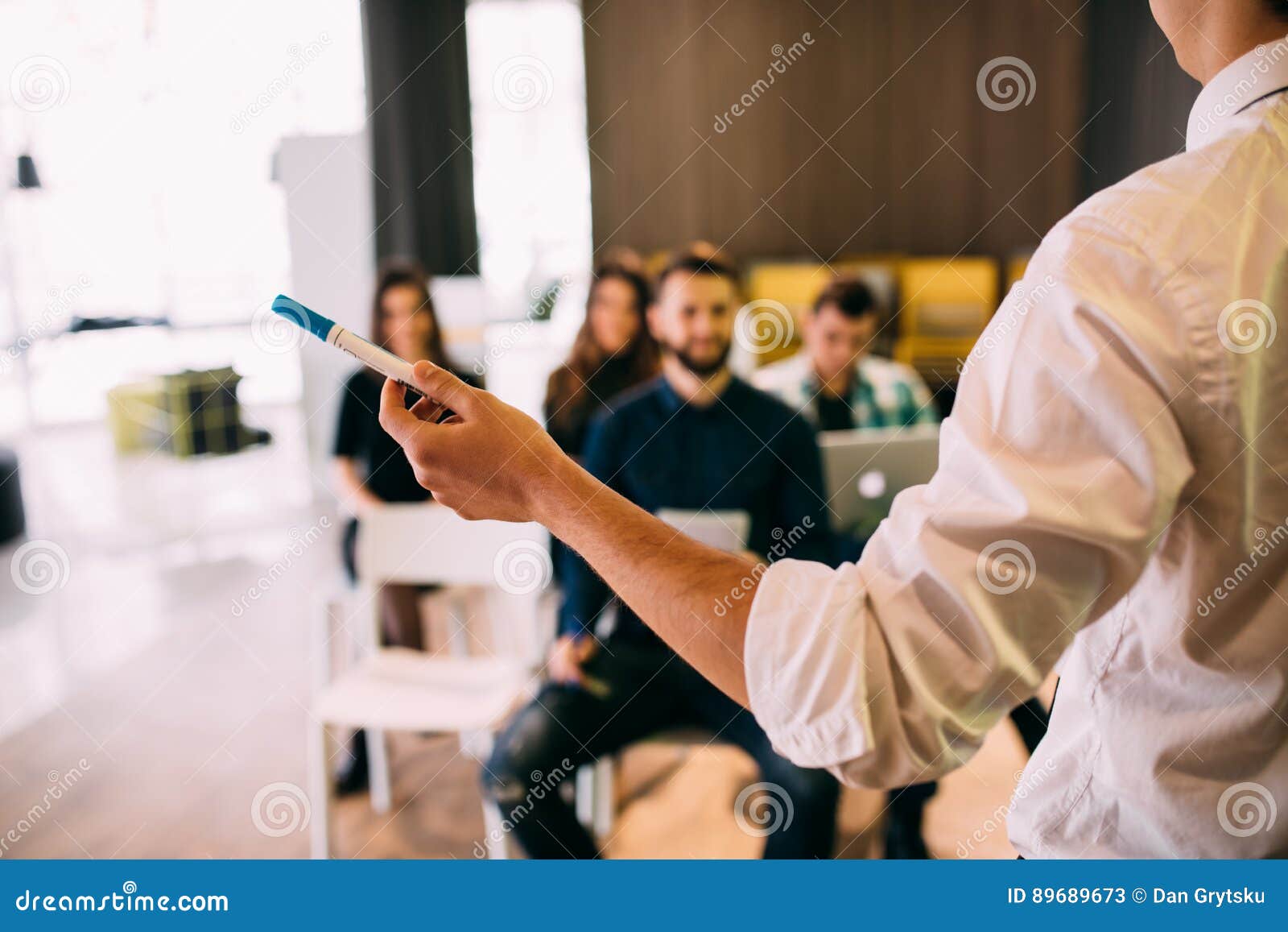 lecture and training in business office for white collar colleagues. focus on hands of speaker.