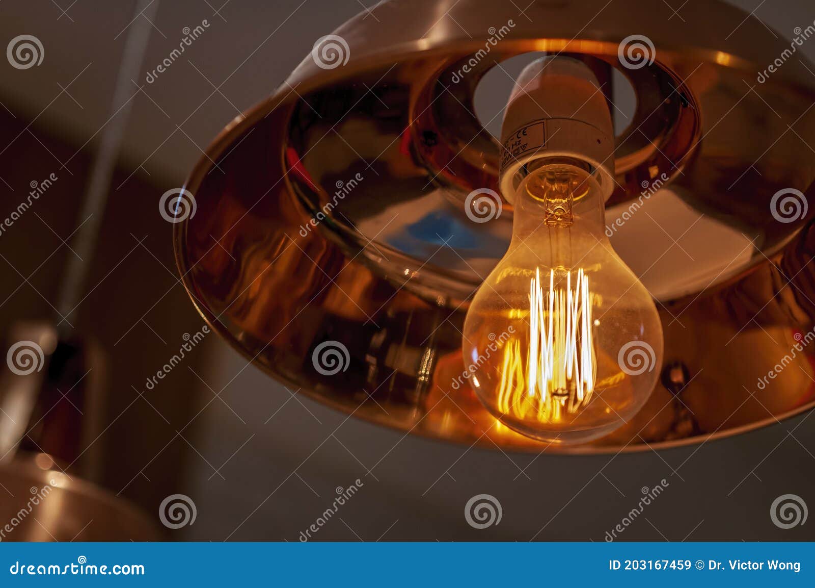 LED Incandescent Light Globe Providing a Warm Orange Glow Stock Image
