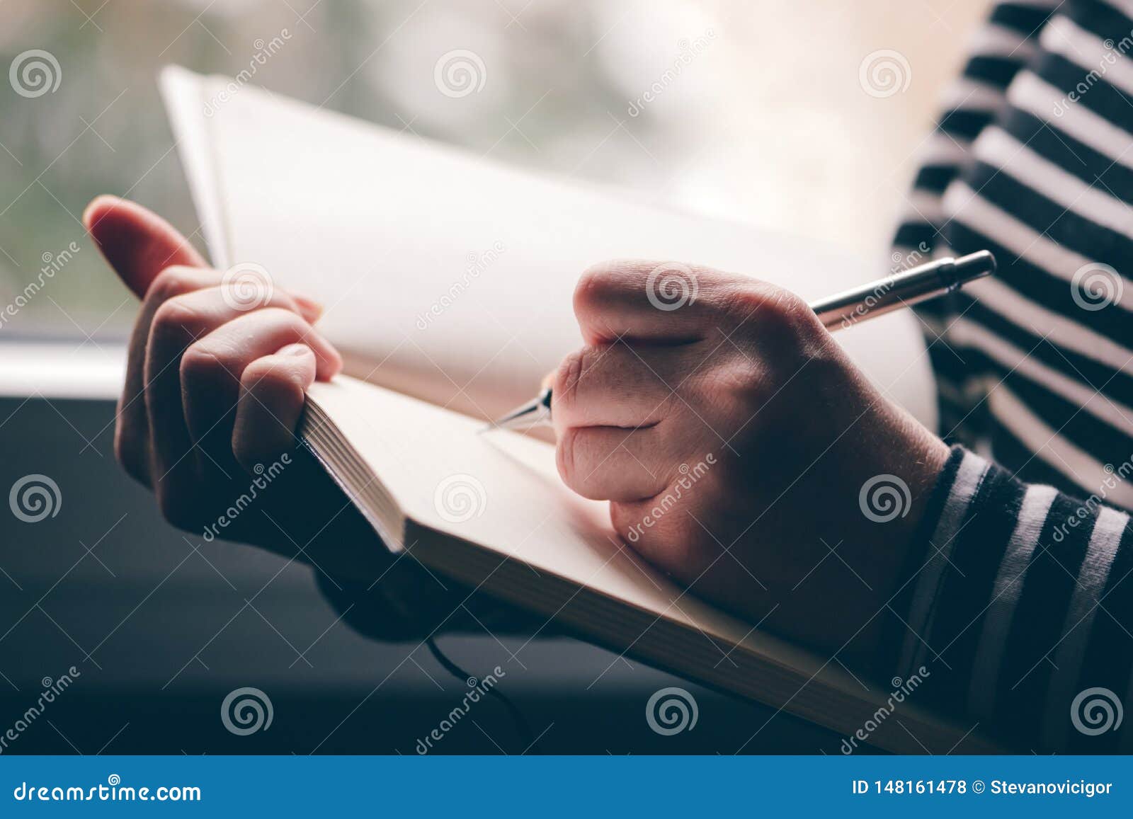 left-handed woman writing diary