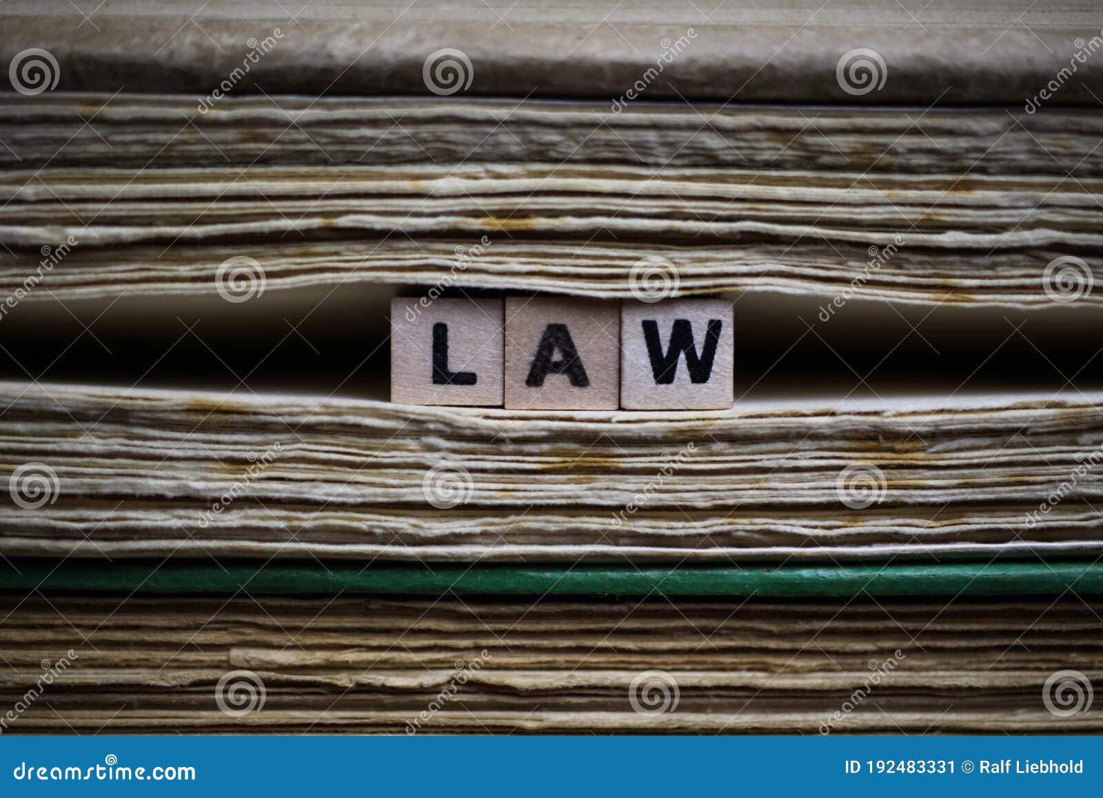 legal conditions framework concept: closeup of  antique old book pile text blocks and yellowed pages with wooden alphabet