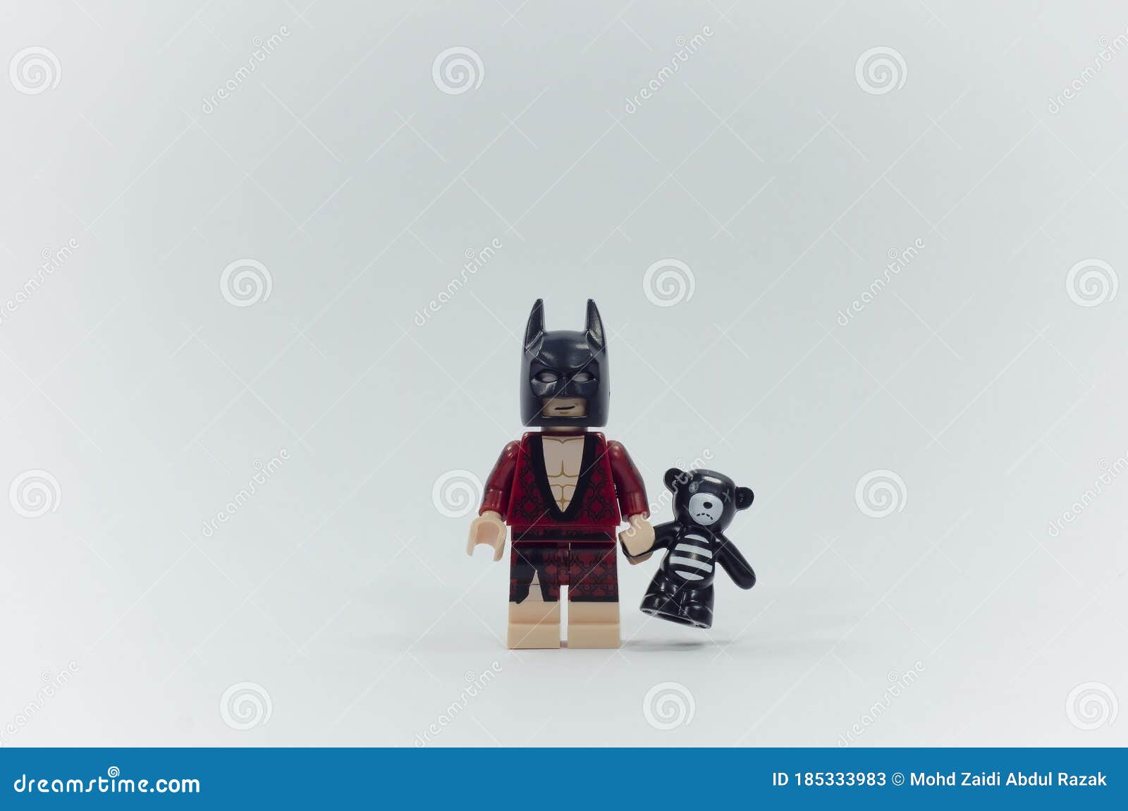 lego batman minifigure holding flower and pink teddy bear Stock Photo -  Alamy