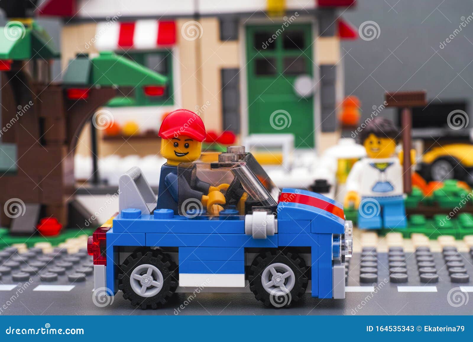 Lego Man Sitting in Blue Car on Road in Front of House Editorial Stock ...