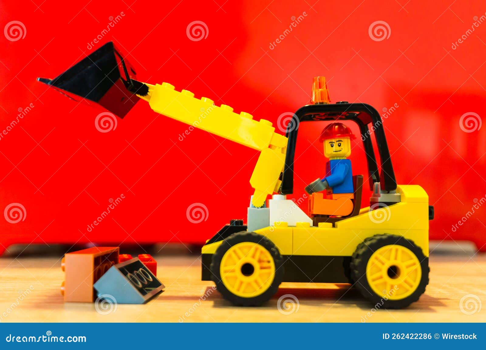 Lego Toy of a Construction Worker Moving Bricks with an Excavator