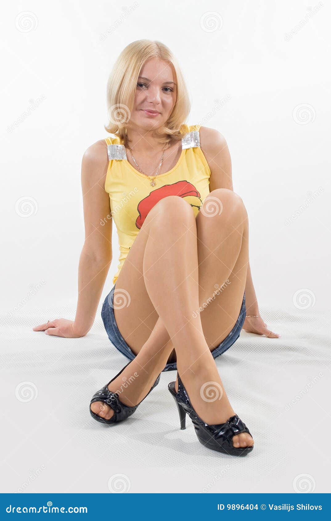 Legs crossed in miniskirt stock photo image