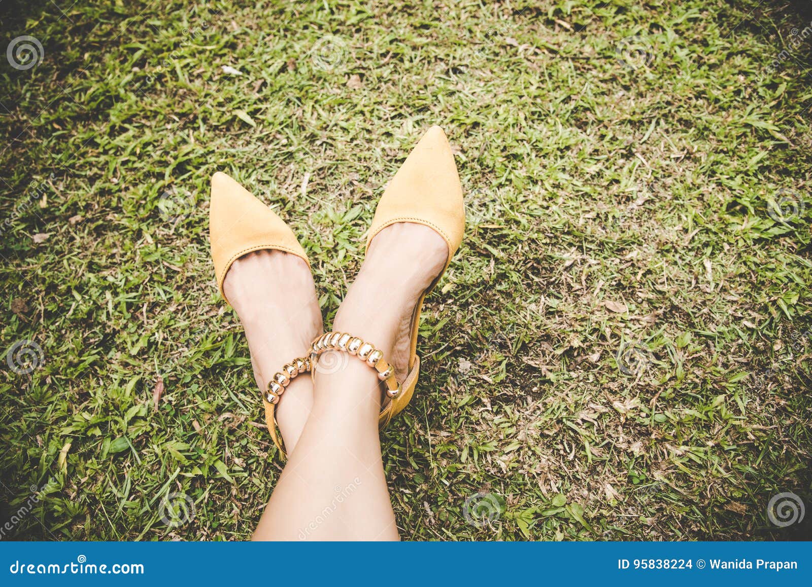 Legs with Fashion High Heel Shoes Yellow on Green Grass with Copy Space ...