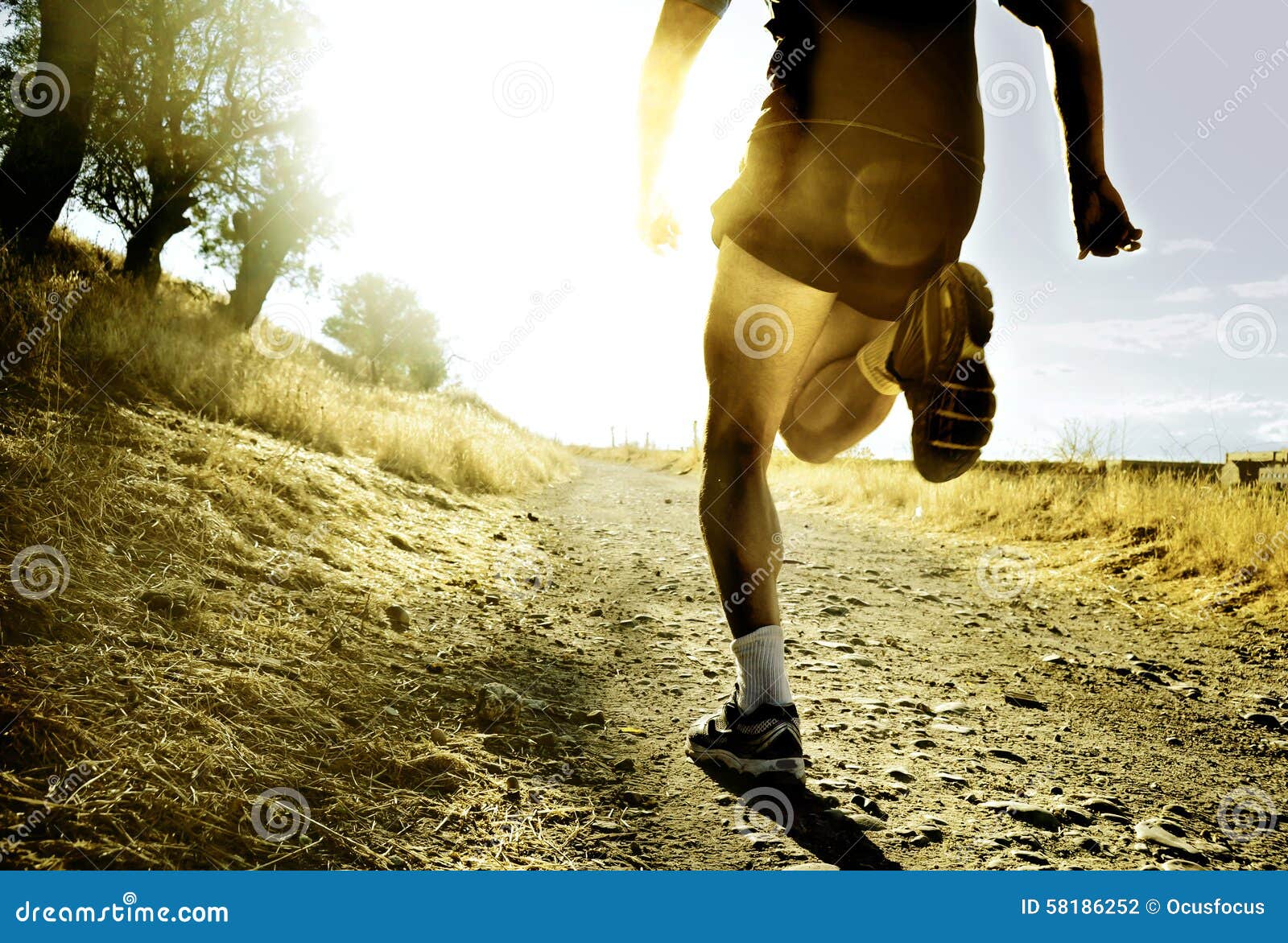 legs and feet extreme cross country man running training at countryside sunset