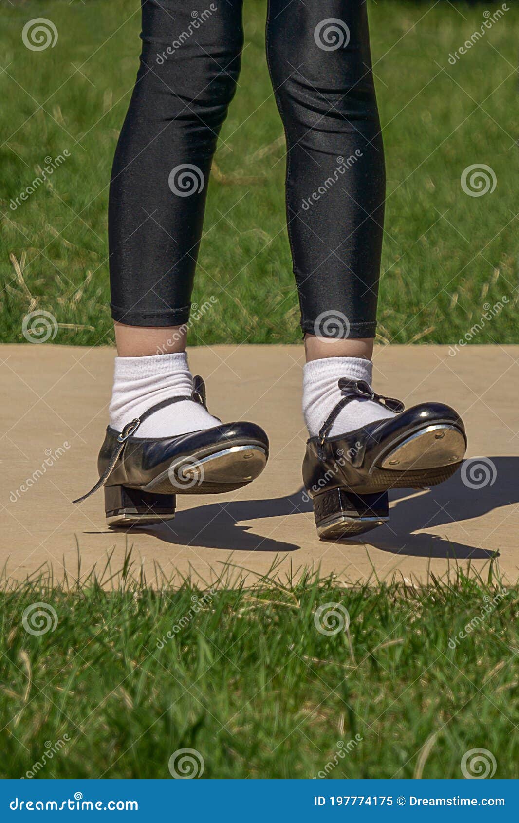 Legs and Feet of Young Girl in Black Tap Shoes, White Socks and