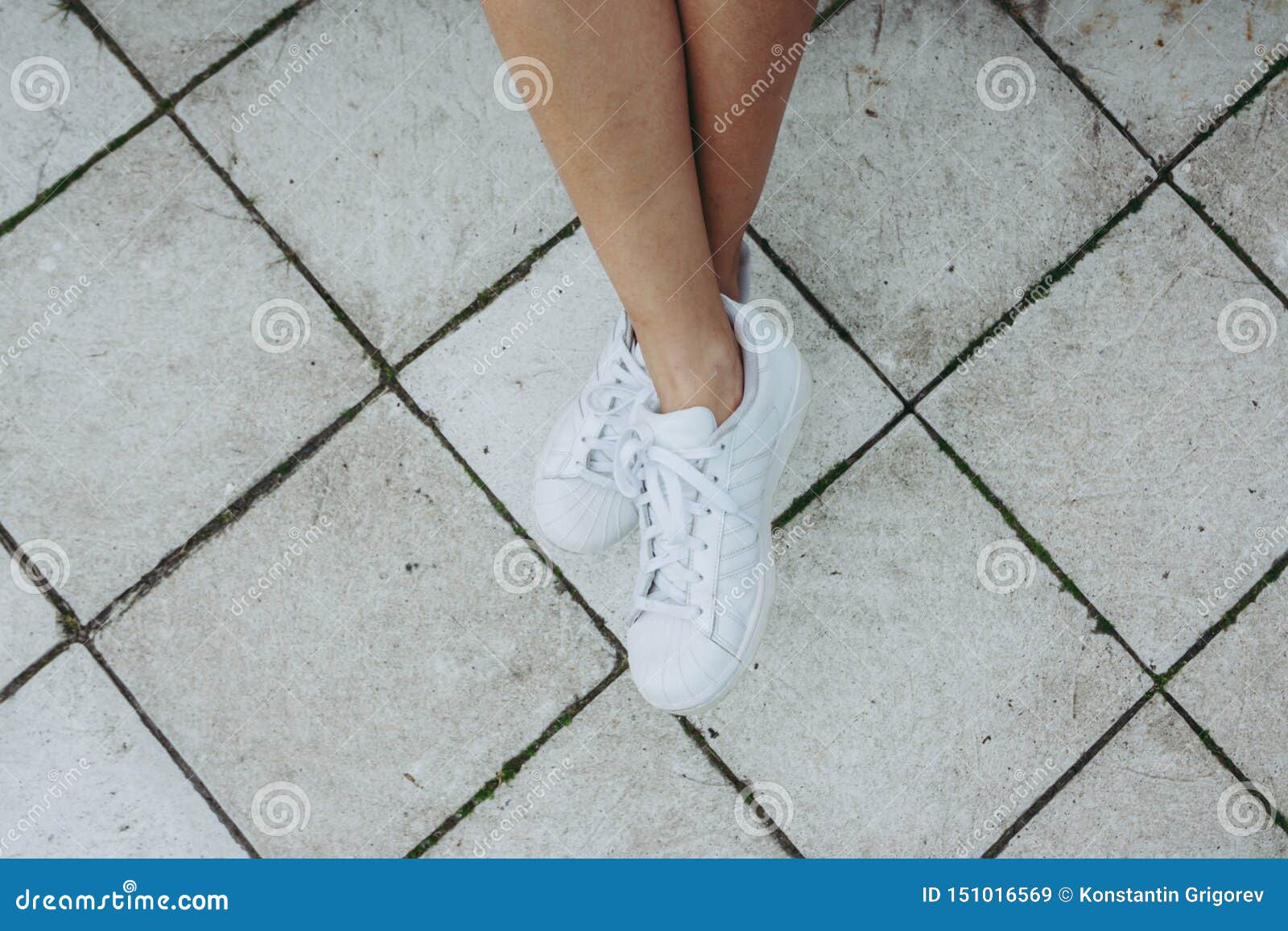 Legs of a Girl in White Sneakers on a Gray Tile Stock Image - Image of ...