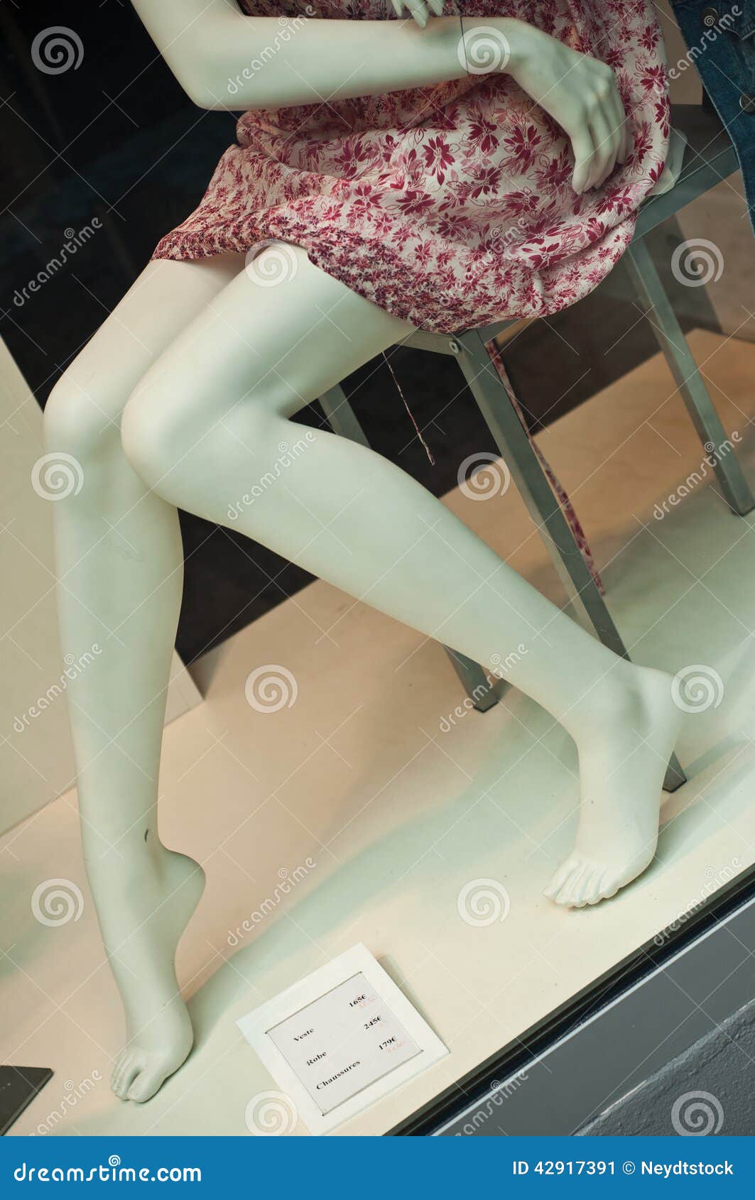 Legs and red dress. Legs closeup mannequin showcase store