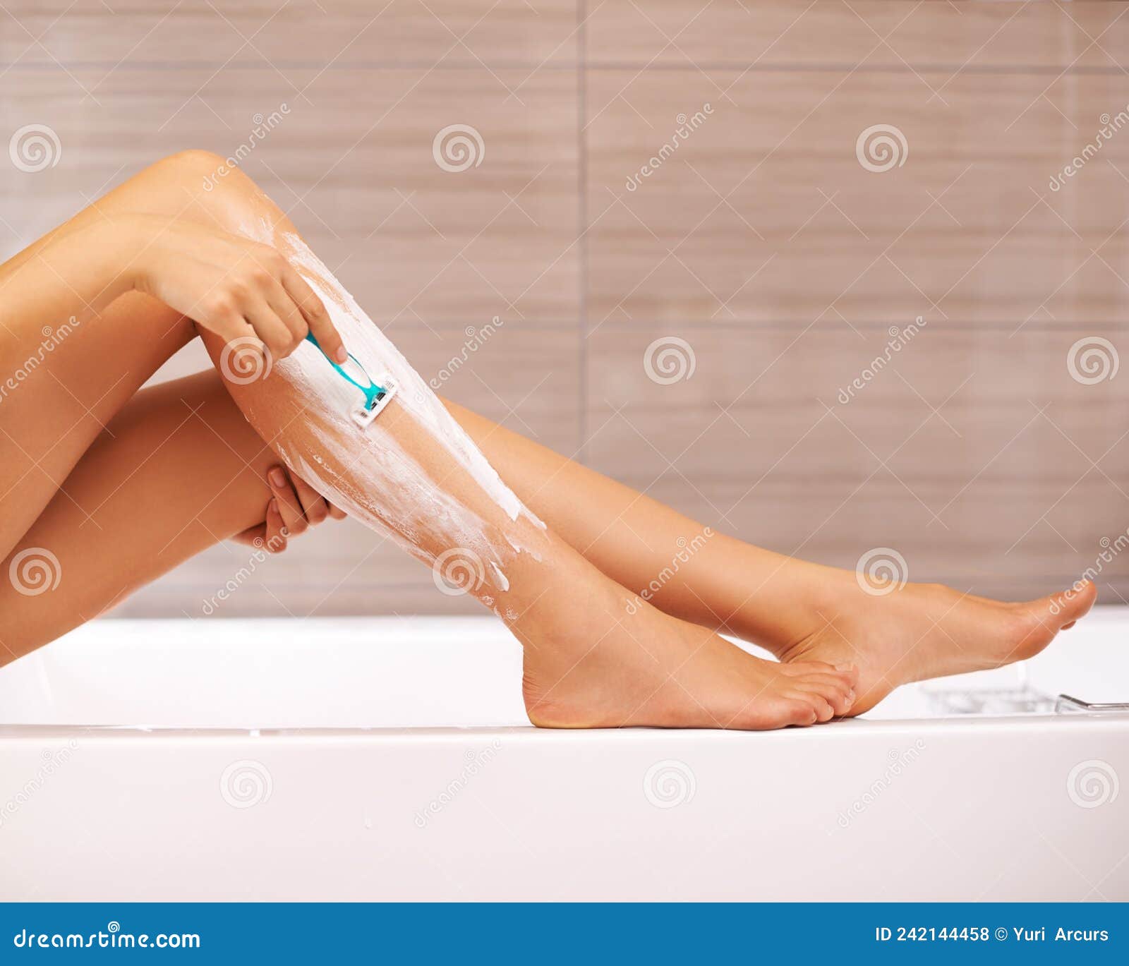 Legs so Smooth. Cropped View of a Woman Shaving Her Legs. Stock Photo Image of body, cropped