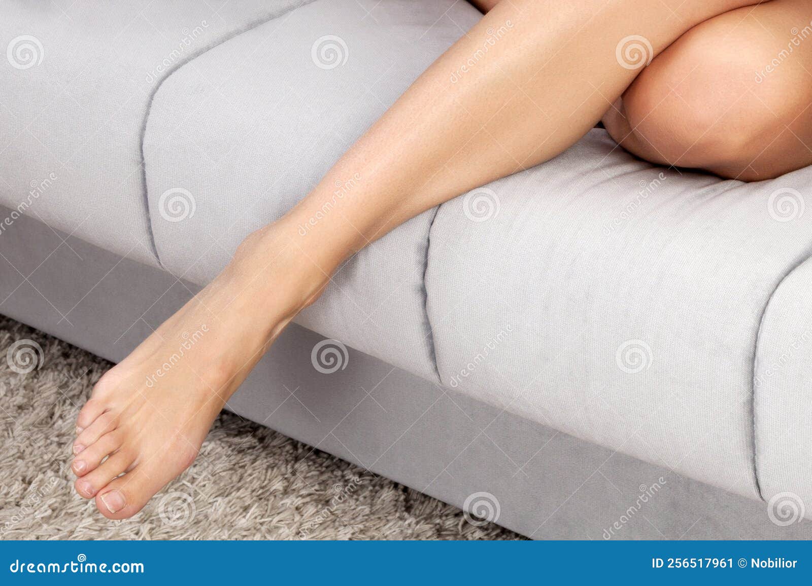 Legs on a sofa stock image. Image of bedroom, home, skin 256517961