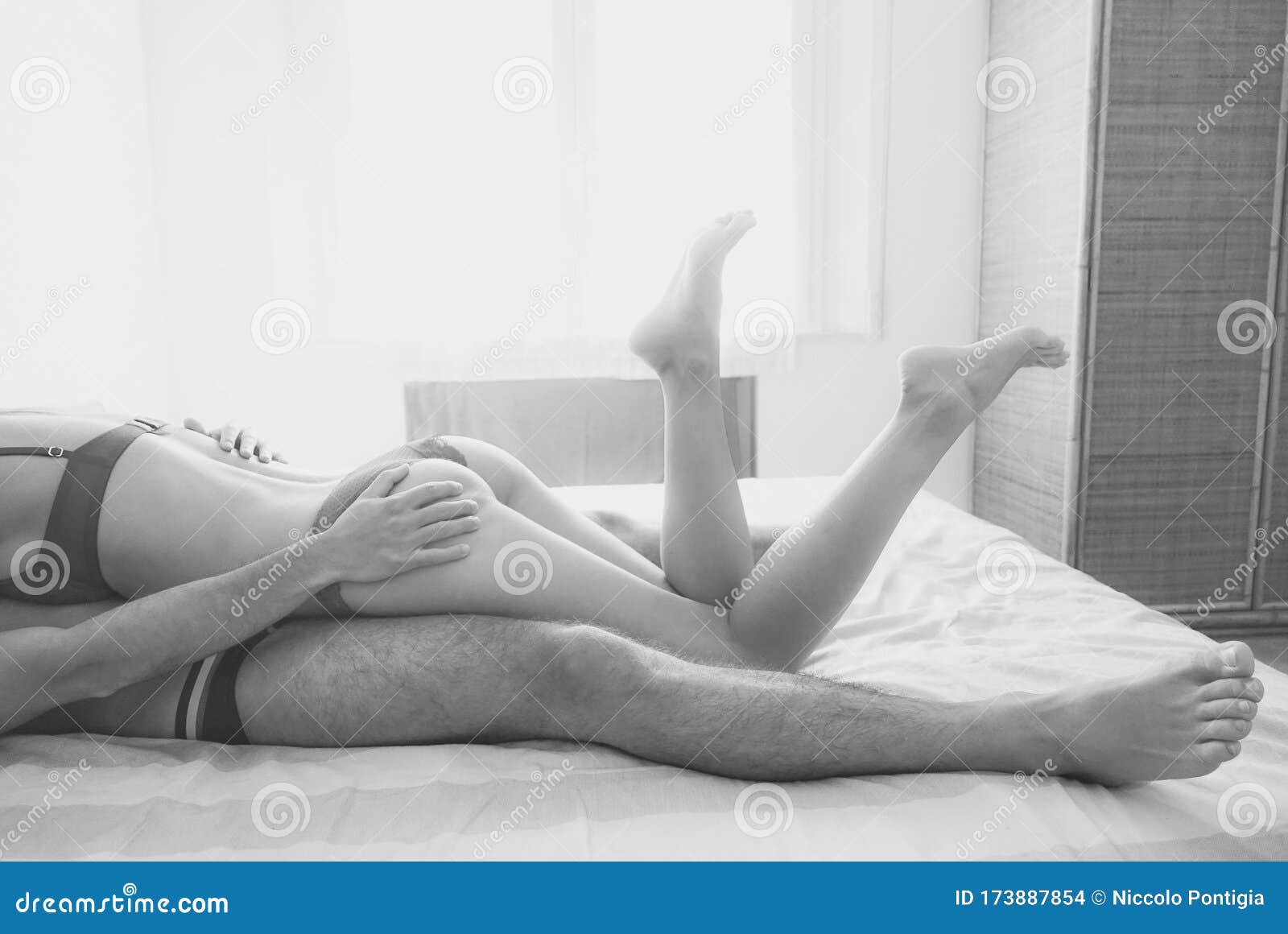 Legs View of Two Lovers before Sex - Passionate Couple Having Sexual Moments Inside Bedroom - Love and Sexuality,sentimental Stock Photo