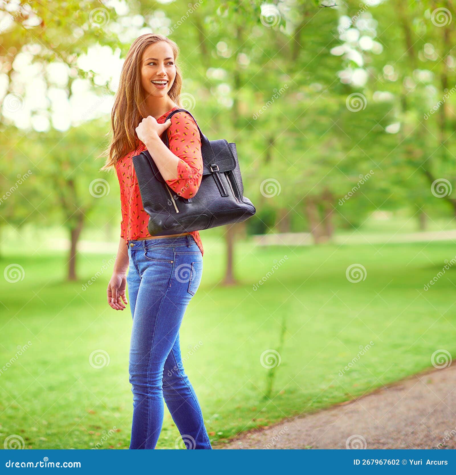 On a Leisurely Stroll through the Park. a Young Woman Walking in a Park ...
