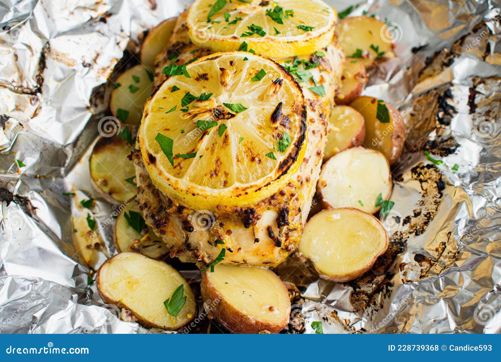 Lemon Chicken and Baby Potatoes Roasted in a Foil Packet Stock Photo