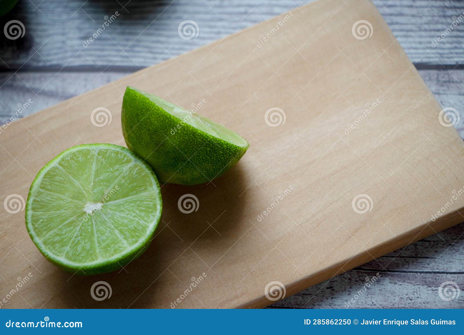 a lemon cut in half on a chopping board