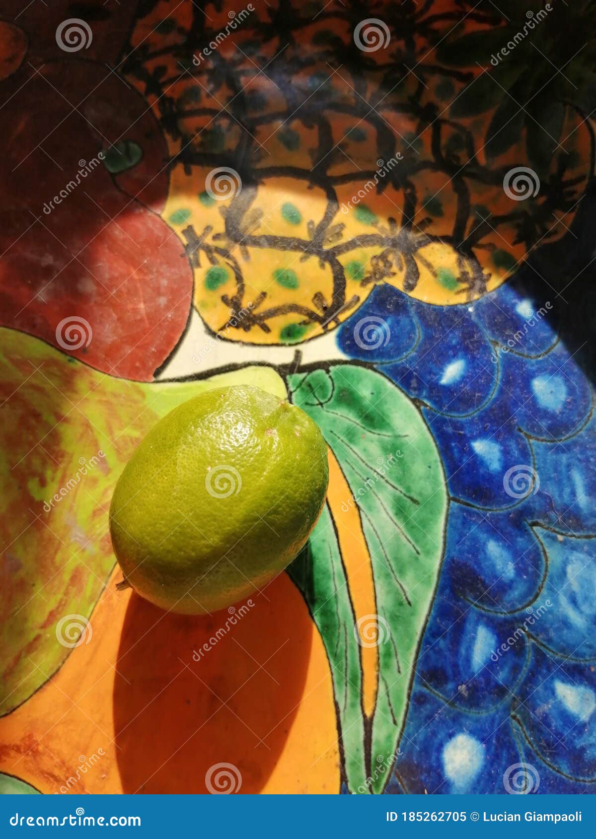 lemon sitting on artesanal vase with the sun hitting directly