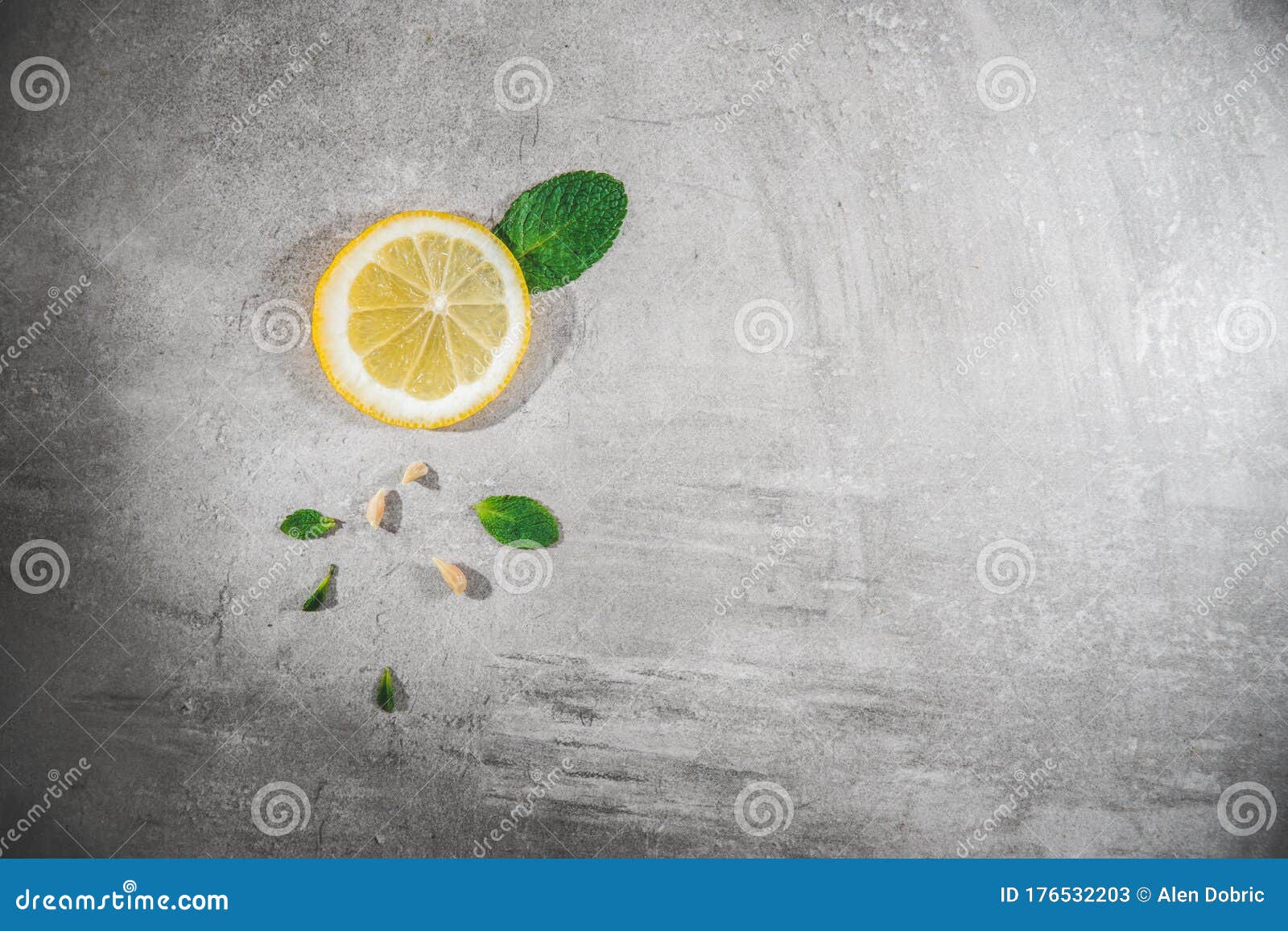 lemon slice with mint leaves on gray table. fresh citrous fruits piece,  with copyspace