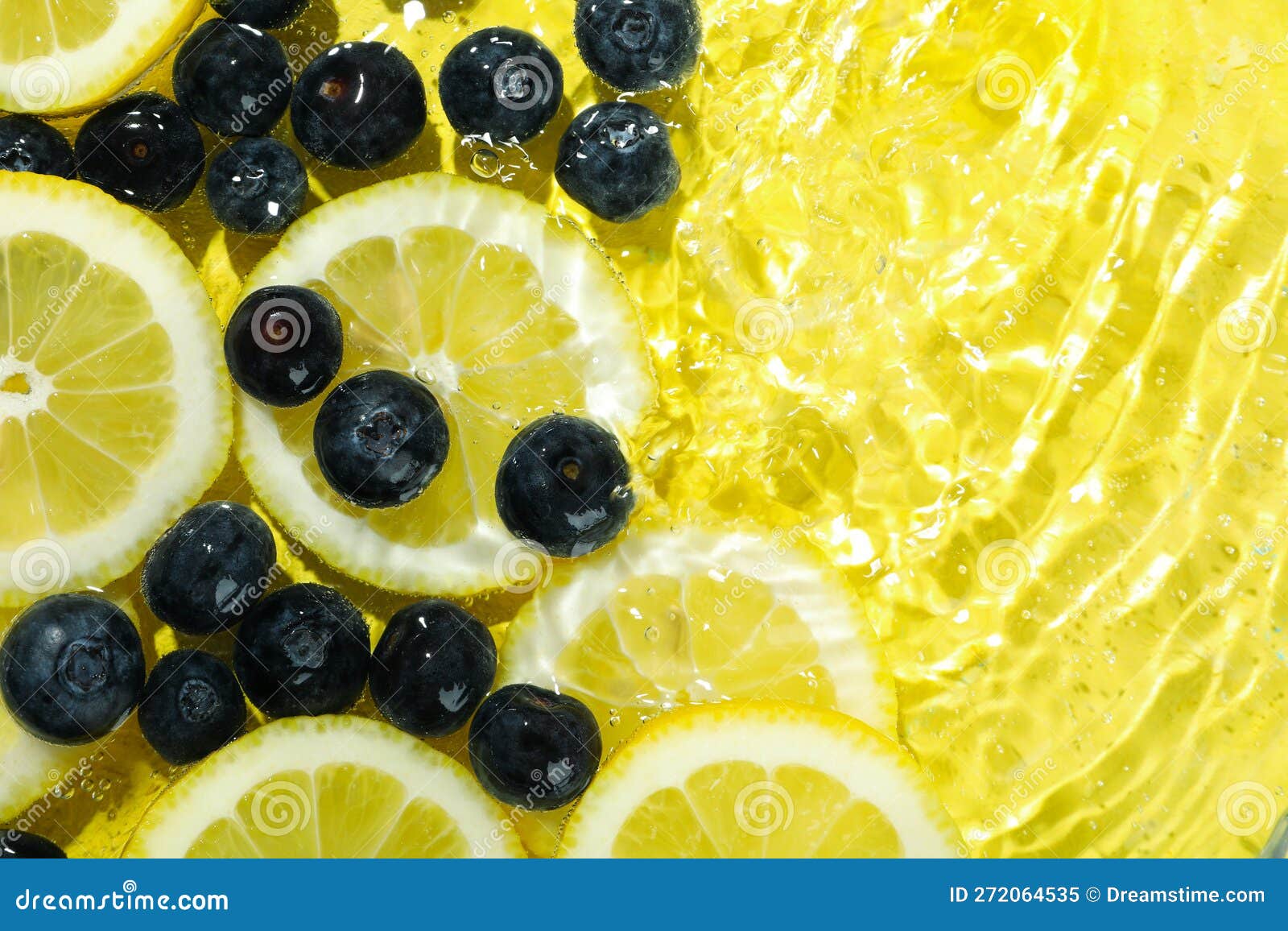 Lemon Slices and Blueberry in Water on Yellow Background Stock Image