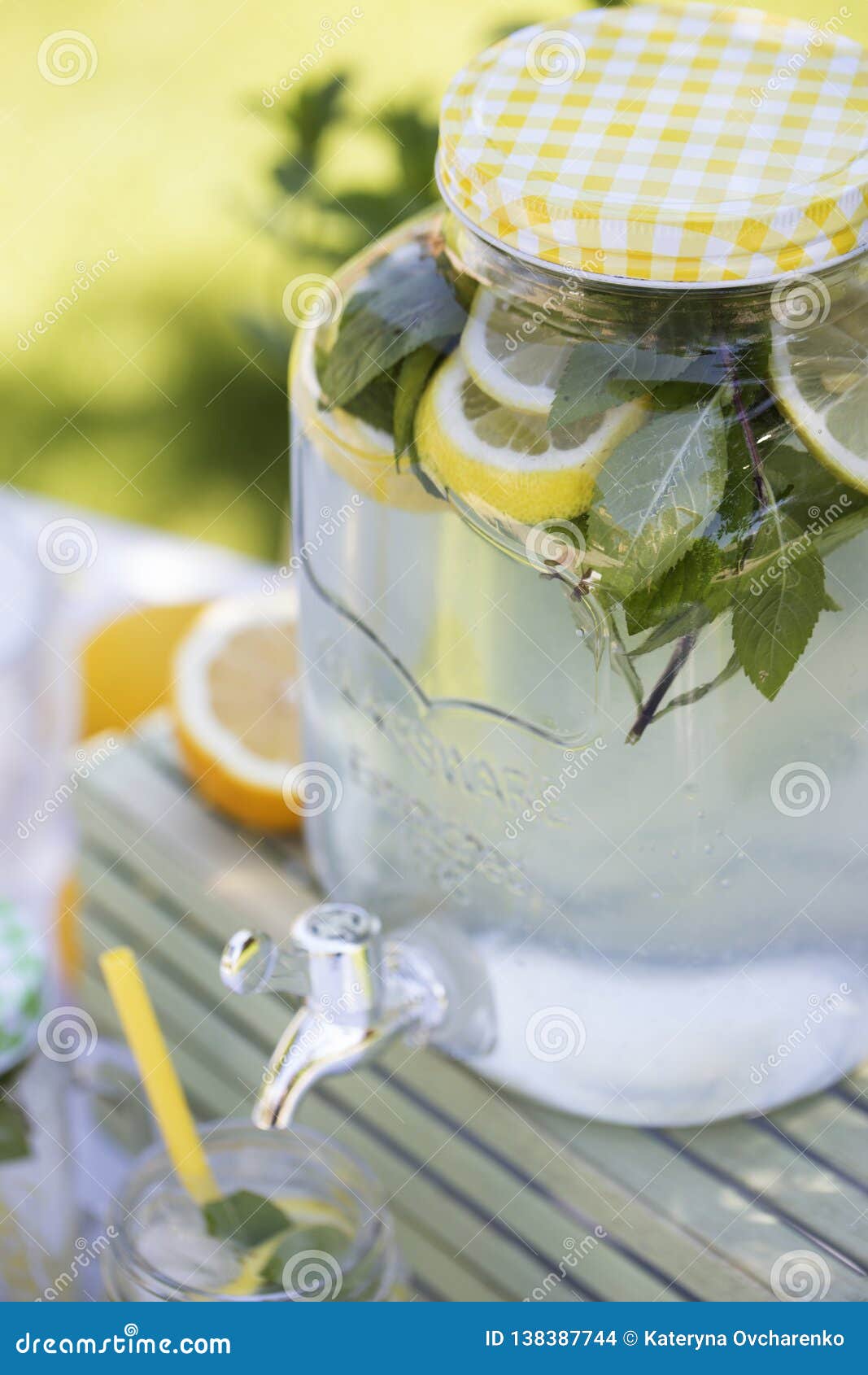 Lemonade in the Jug and Lemons with Mint on the Table Outdoor