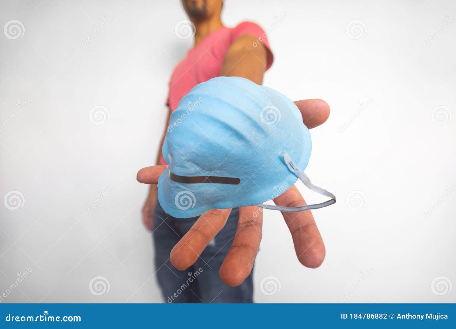 selective focus on the foreground of mask that man delivers to protect you from an infection on white background. social distance