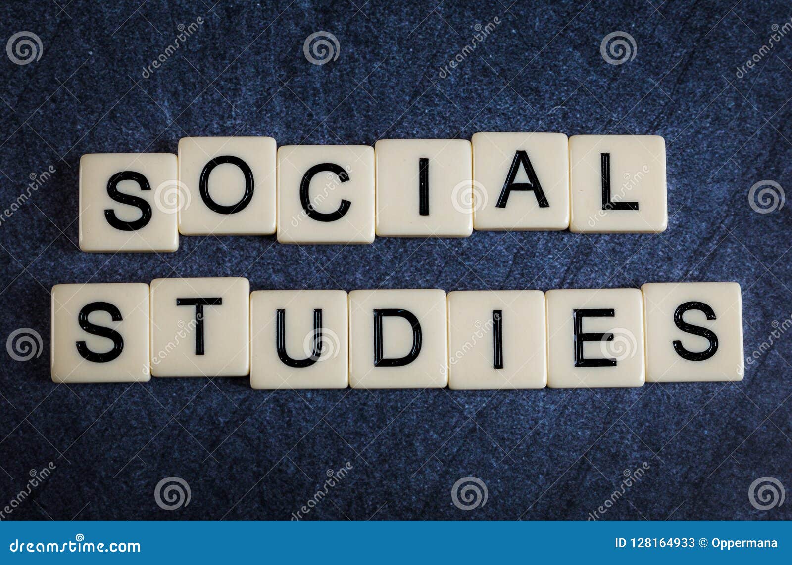 letter tiles on black slate background spelling social studies