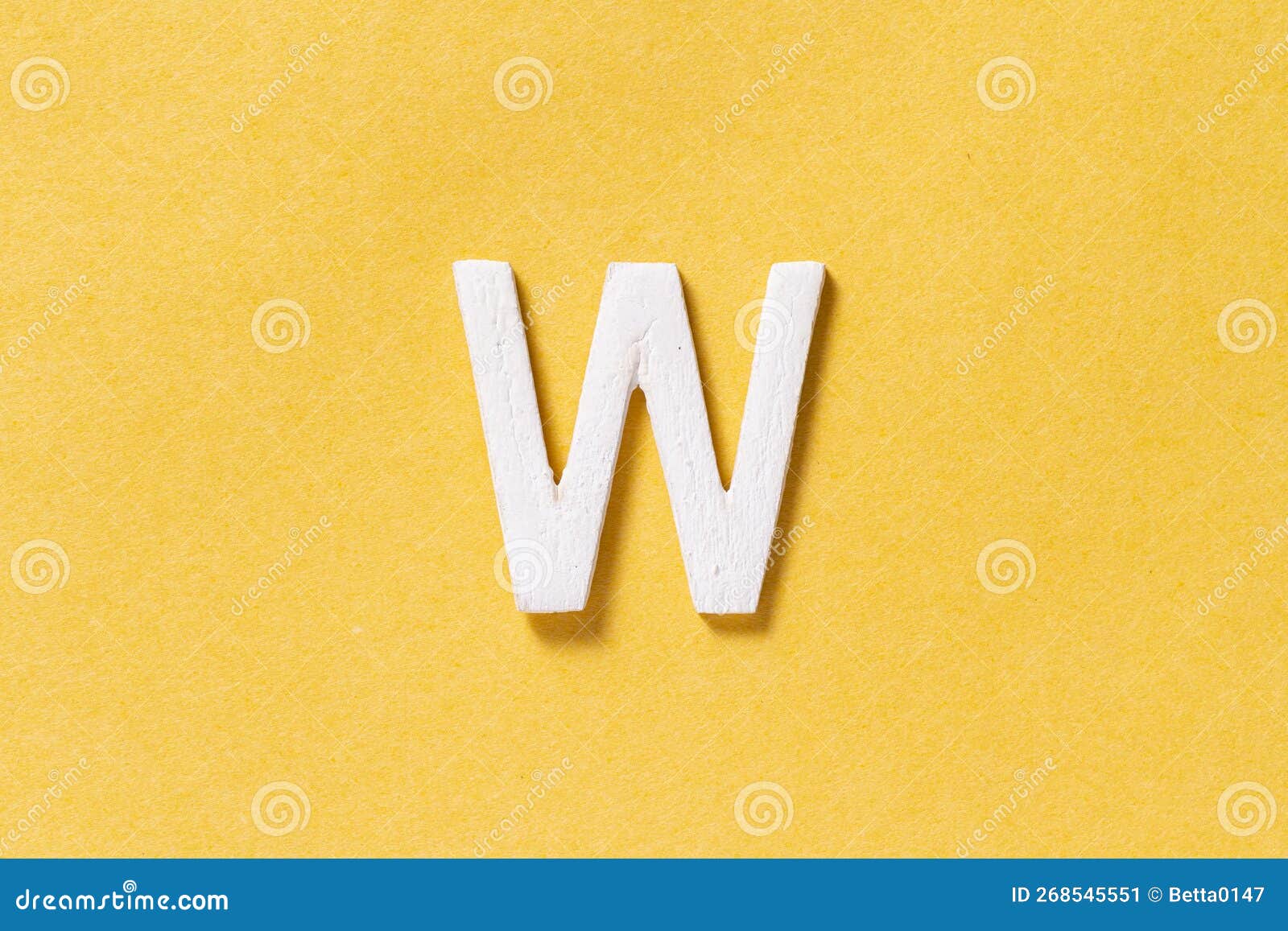 Letter W of the Alphabet Isolated on Yellow Background, Top View Stock