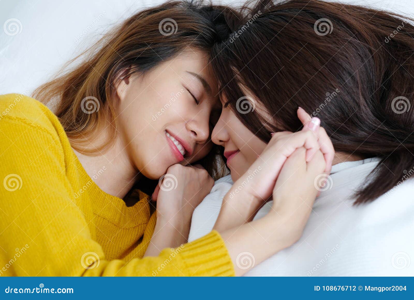 LGBT, Young Cute Asia Lesbians Lying and Smiling on White Bed To Stock Photo photo pic