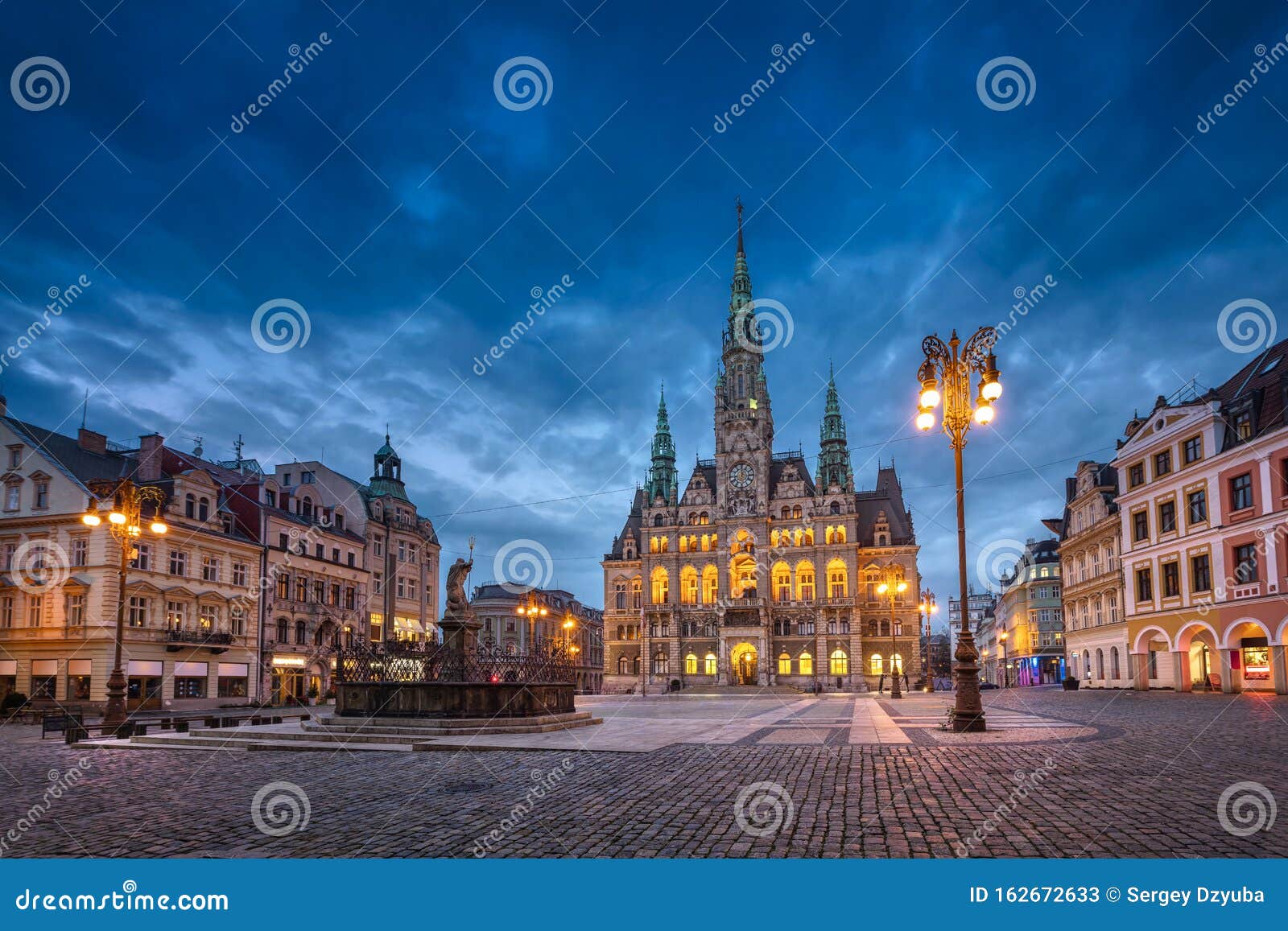 liberec, czechia. view of main square with town hall at dusk