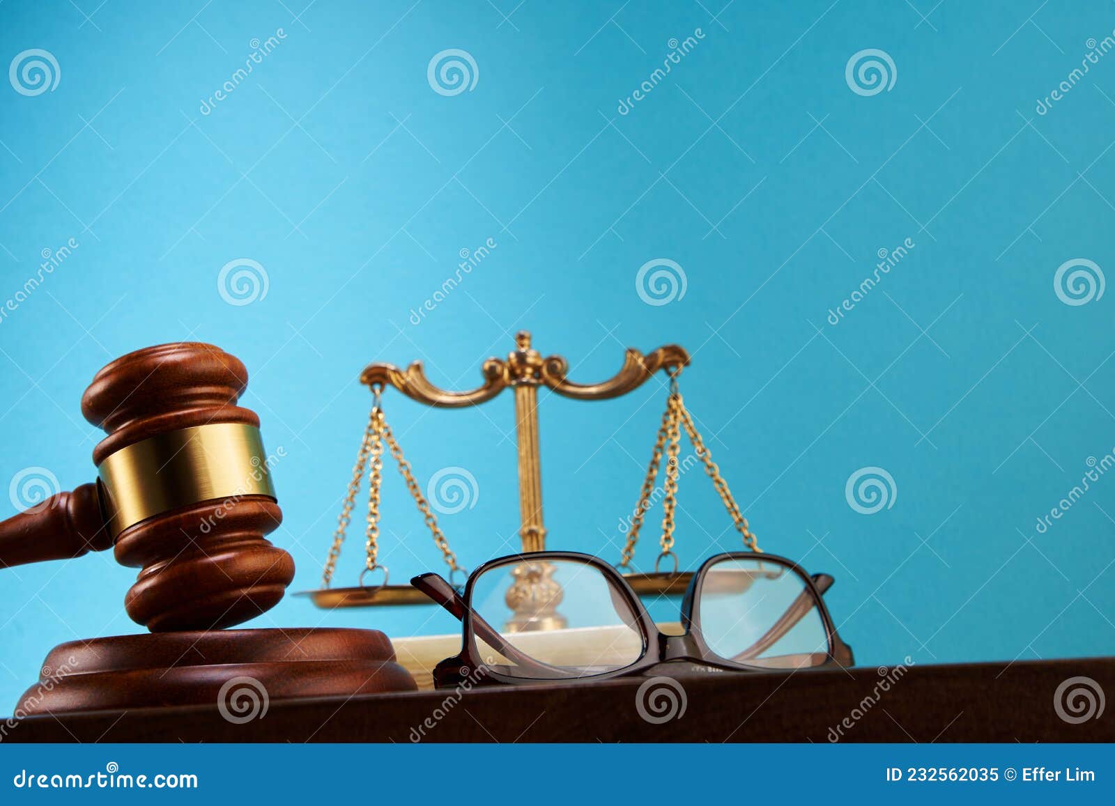 Libra Scale and Gavel Hammer Against Blue Background Stock Image