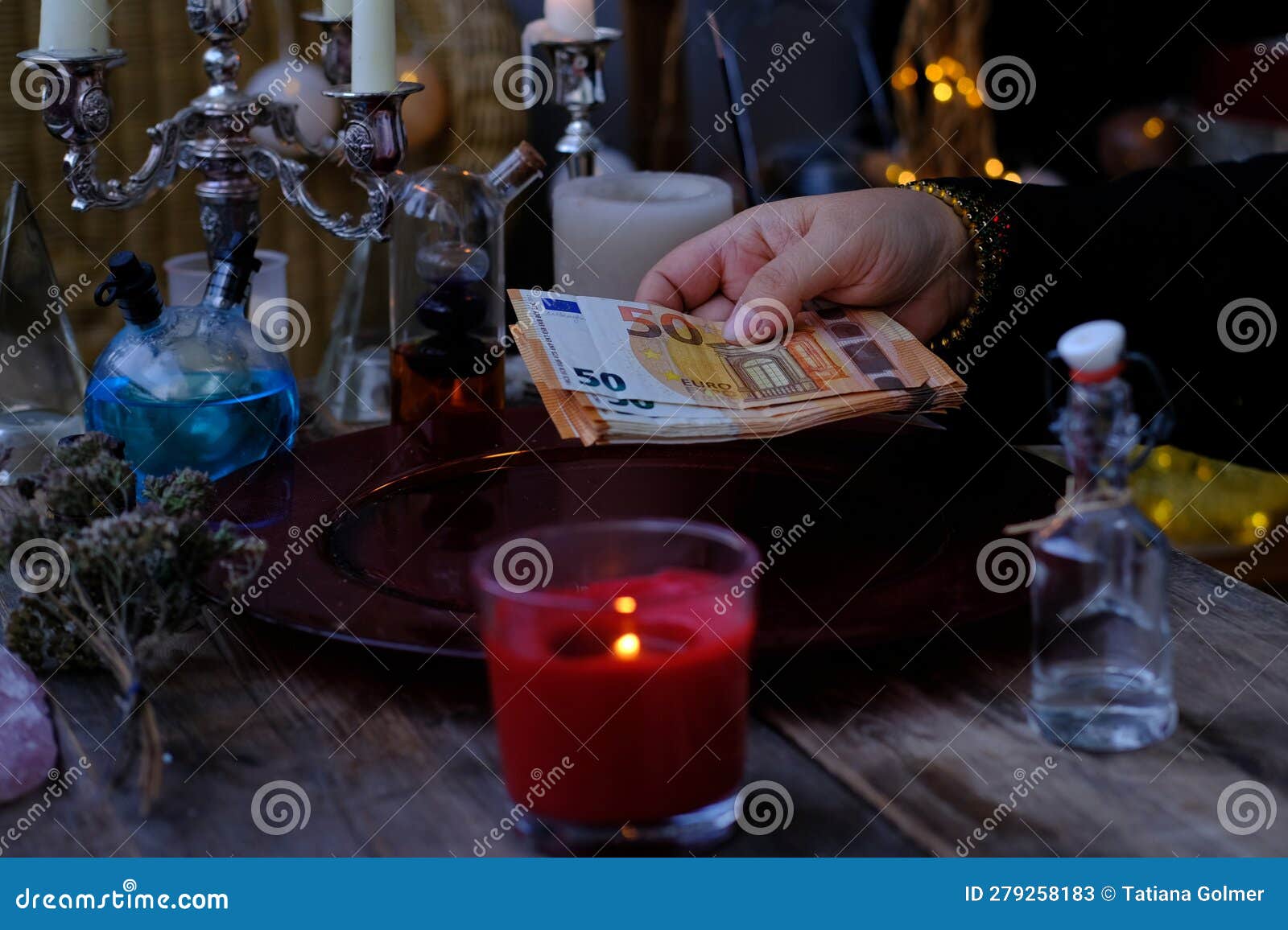 librate with money, female hands of psychic doing witchcraft passes with euro banknotes, esoteric oracle performs ritual of