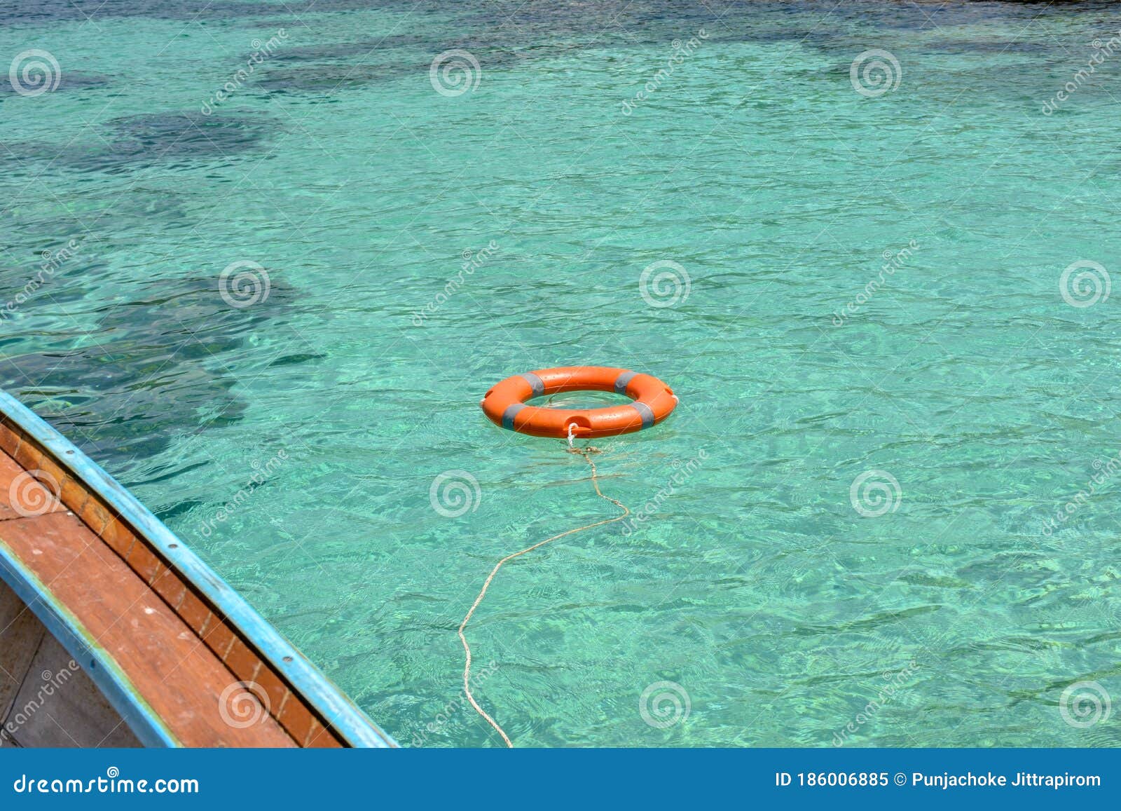 Life Buoy Floating on Clear Blue Sea Water Near the Tourist Boat. Stock ...