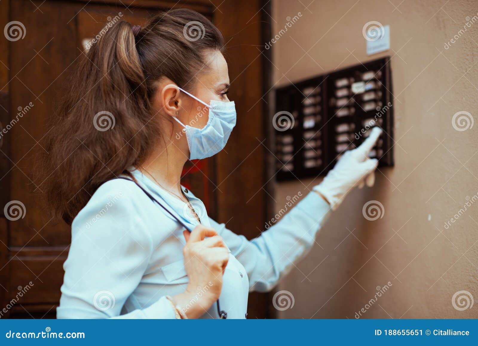 Elegant Woman in Blue Blouse with Gloves Ringing Doorbell Stock Image ...