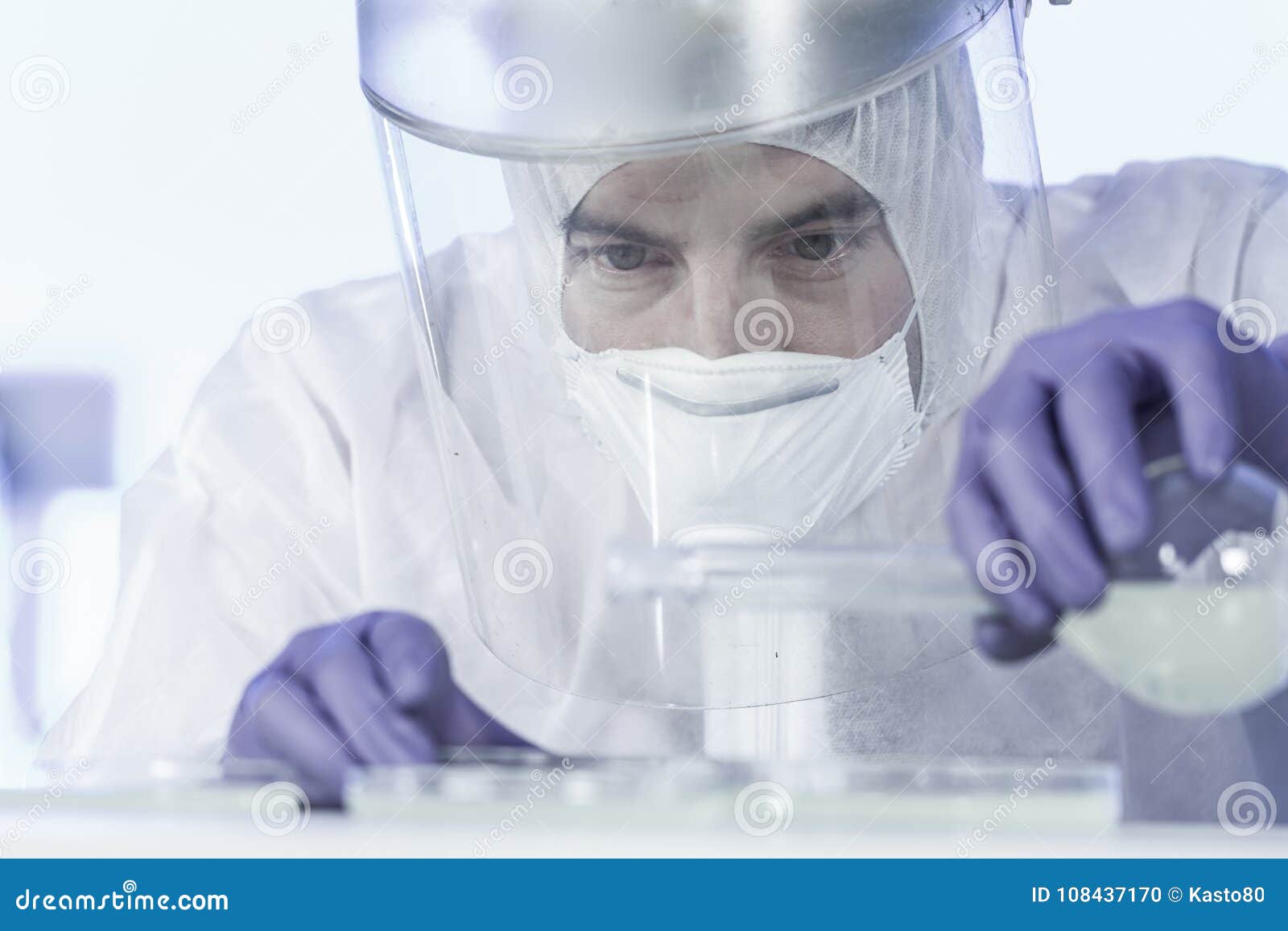 life scientist researching in bio hazard laboratory. high degree of protection work.