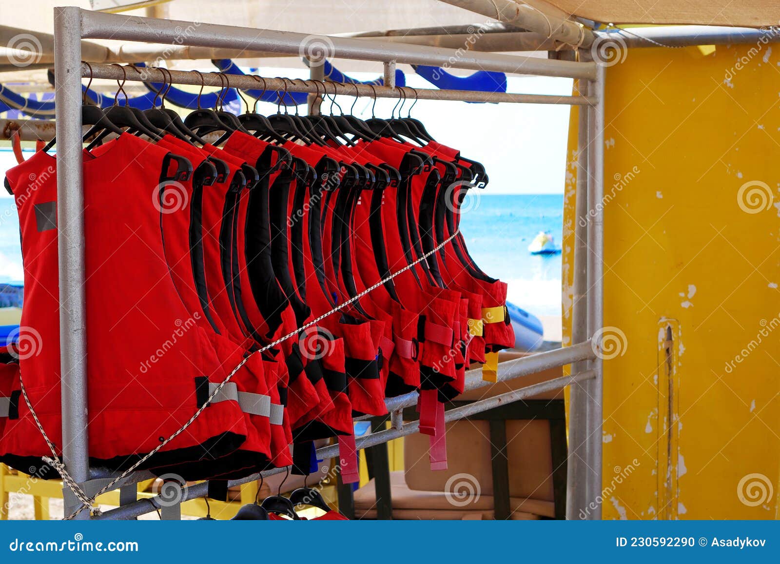 Life Vests Hanging on a Rack. Red Lifejackets for Watersport Activity