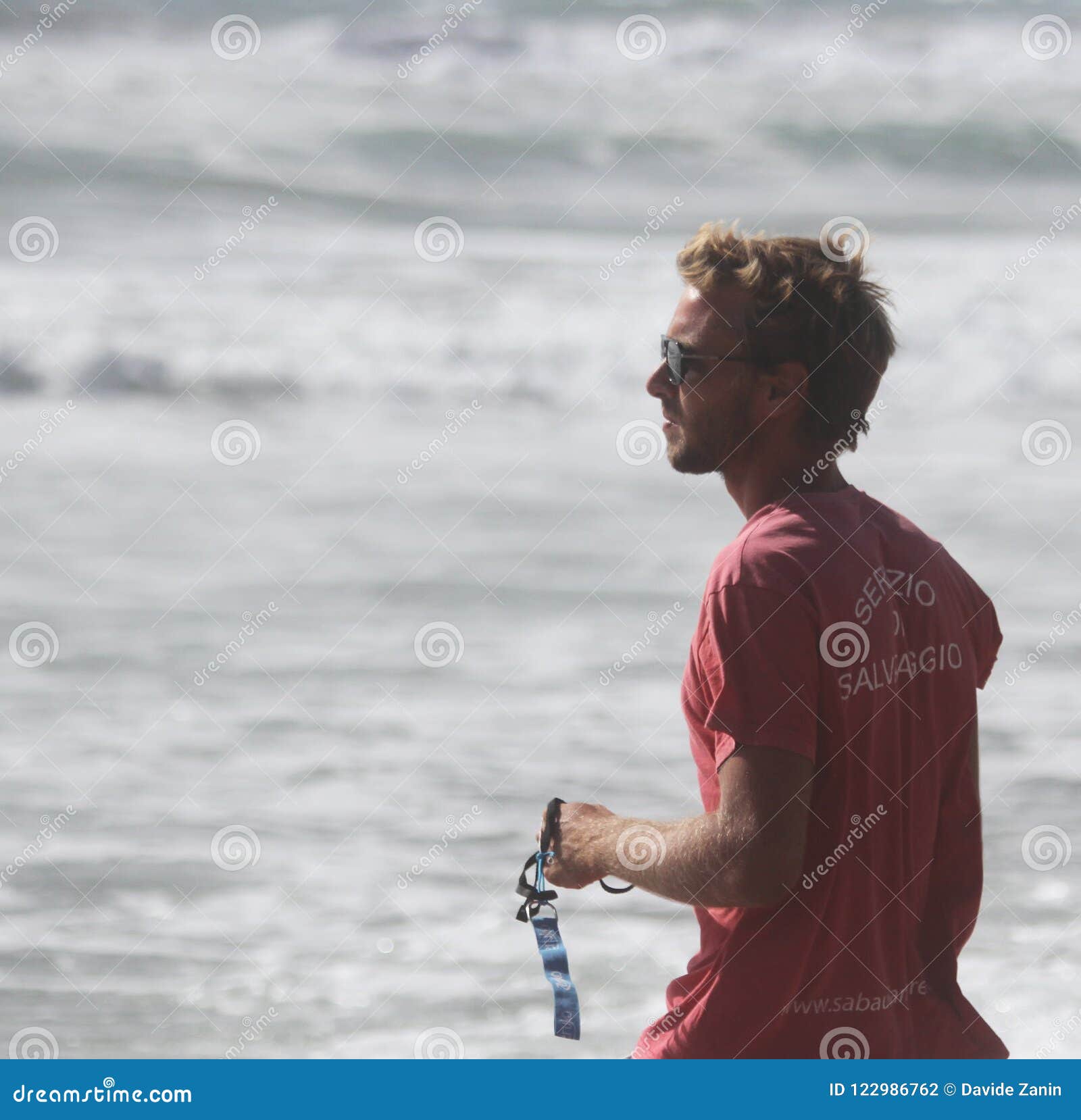 Lifeguard on the Beach Looking Carefully at the Sea. Rough Sea in the ...
