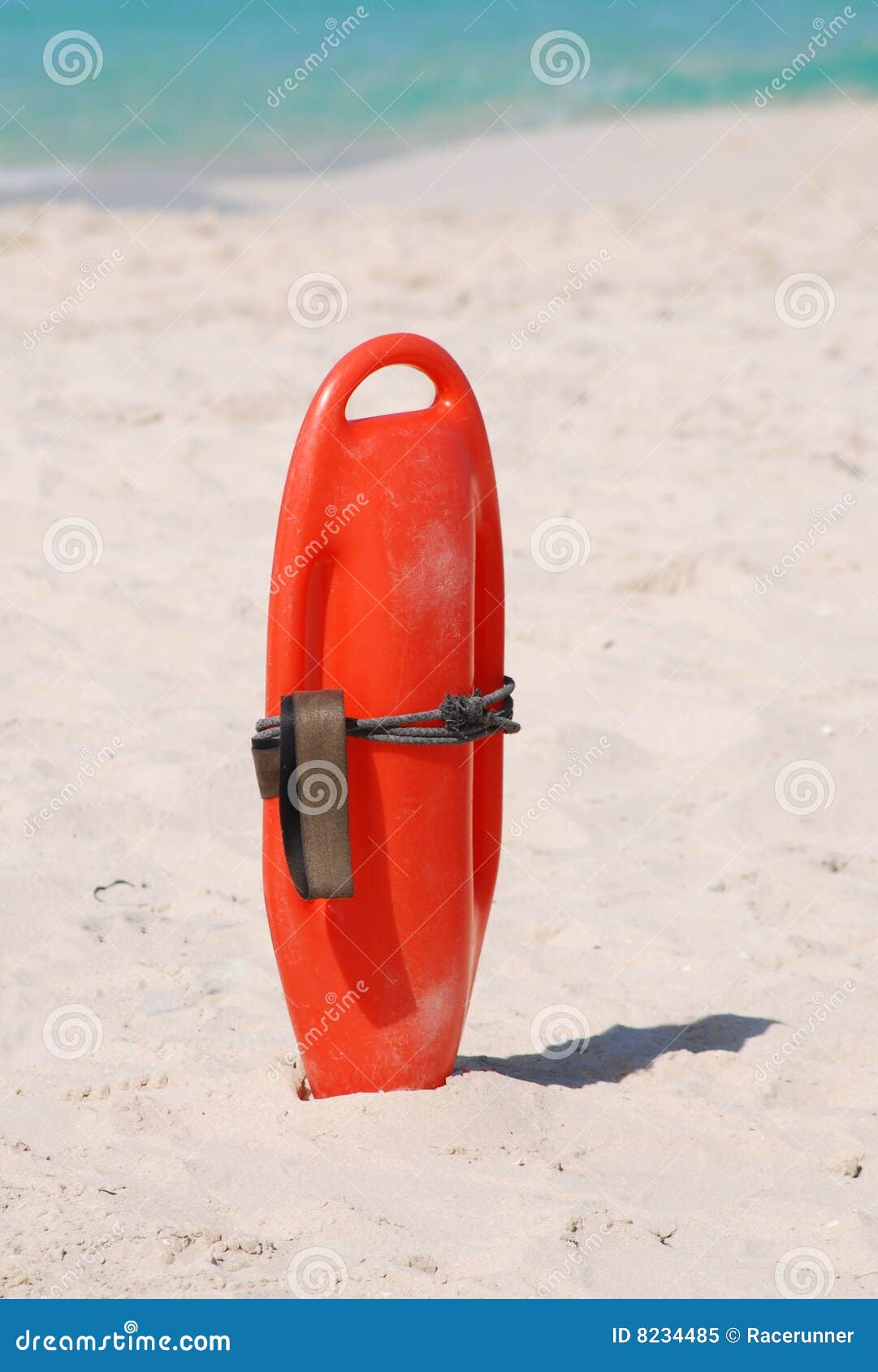 lifeguard buoyancy aid sticking in the sand