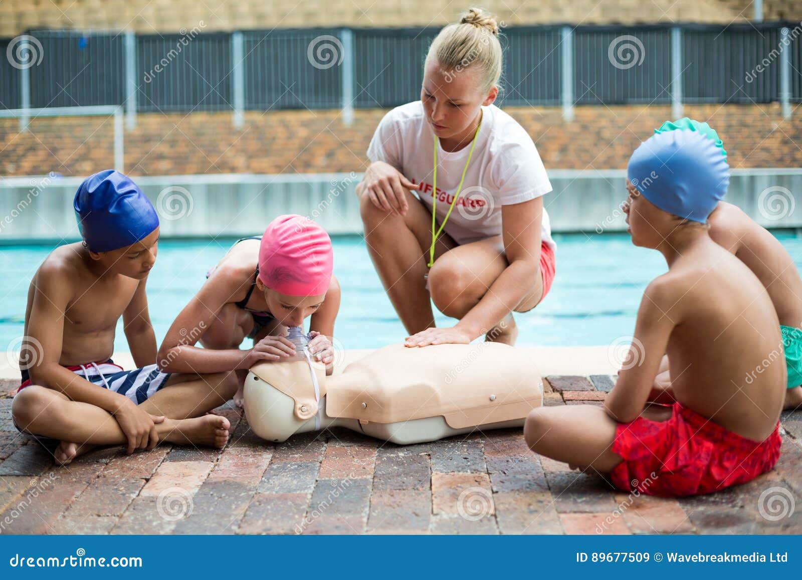 lifeguard helping children during rescue training