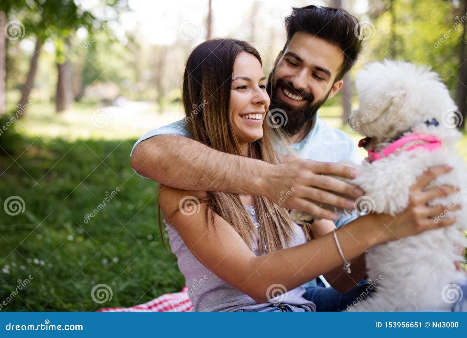 Lifestyle Happy Couple Resting At A Picnic In The Park With A Dog